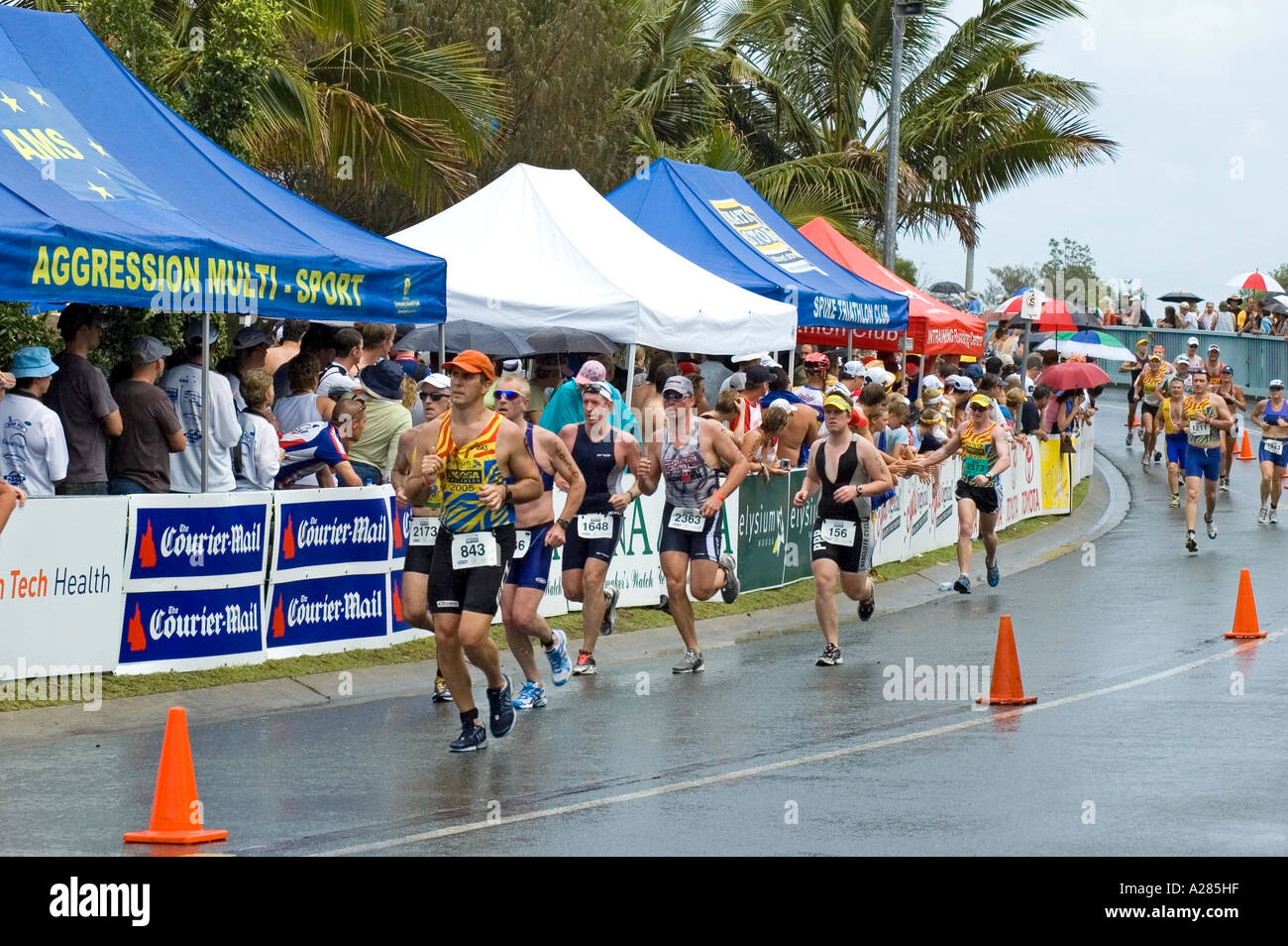 Men and women run to the finish of a triathlon, Noosa, Queensland, Australia. DSC 7848 Stock Photo