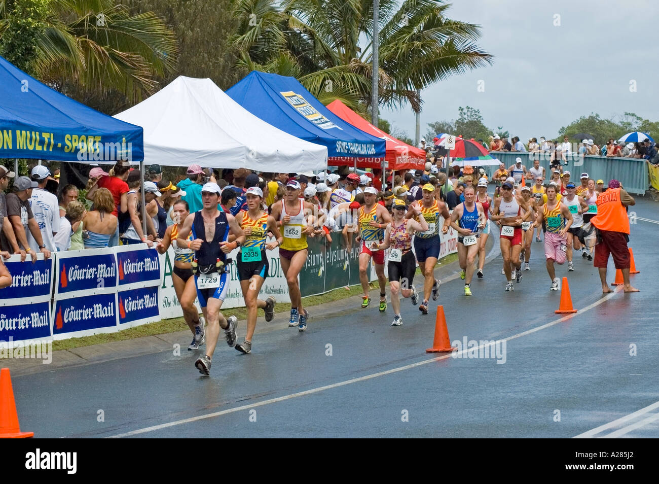 Men and women run to the finish of a triathlon, Noosa, Queensland, Australia. DSC 7849 Stock Photo