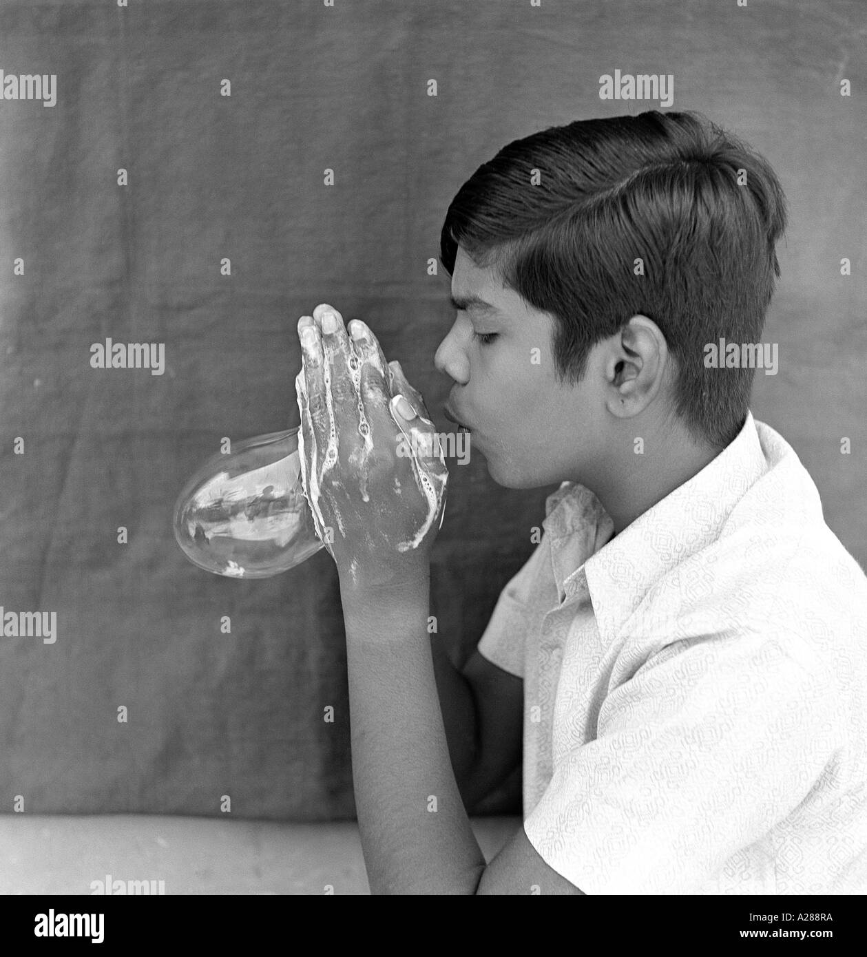 boy blowing soap bubble Stock Photo