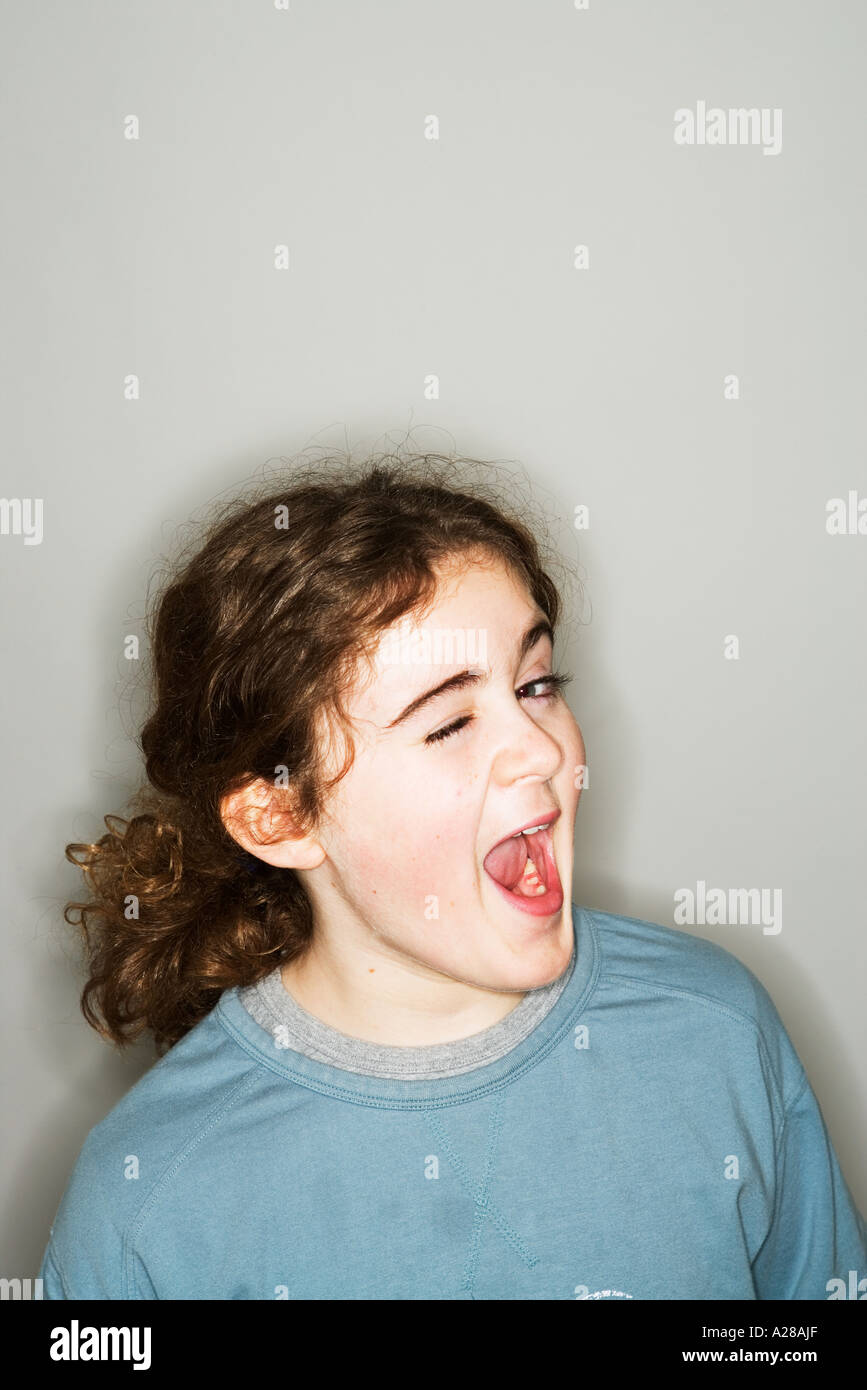 PORTRAIT OF 11 YEAR OLD BOY PULLING FACE Stock Photo
