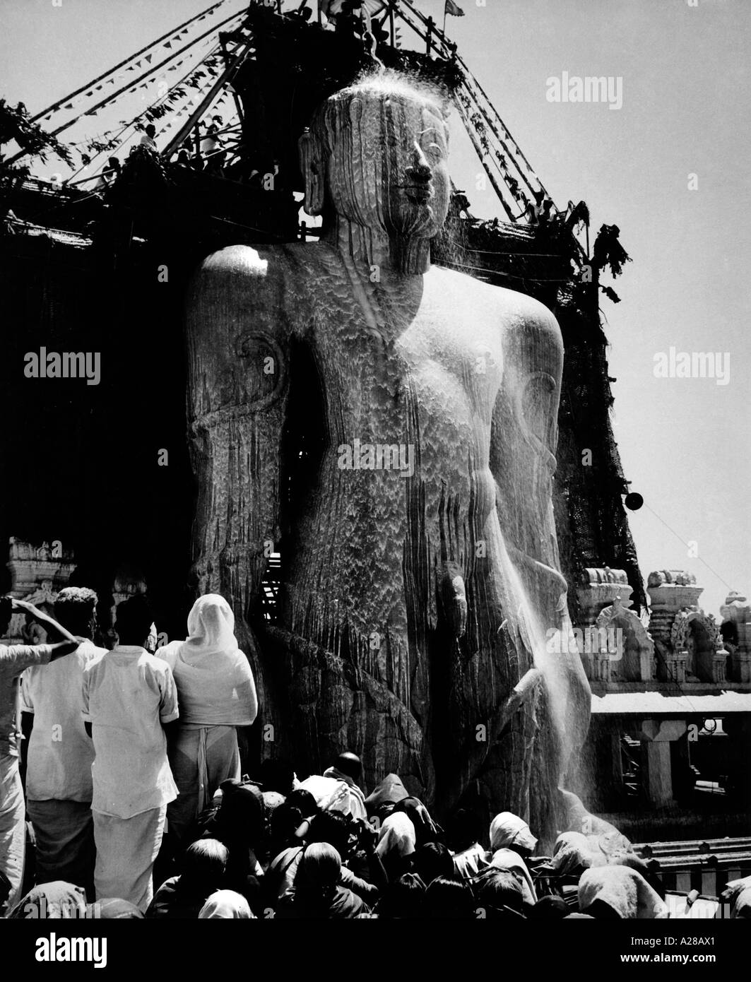 TSS76417 The gigantic statue of Jain Gomateshwara being bath in milk India Stock Photo