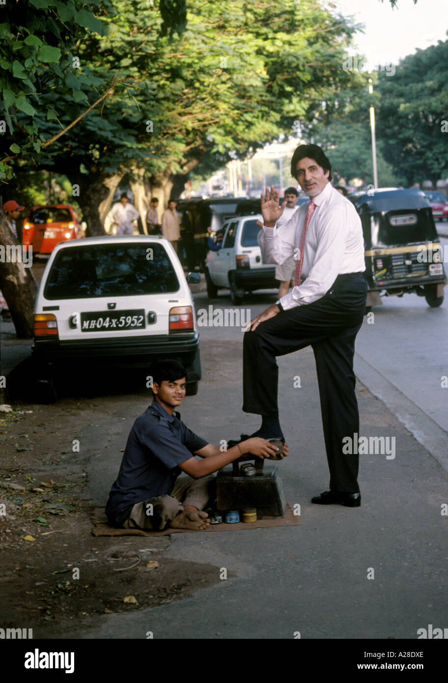 Indian Bollywood Film Star Actor Amitabh Bachchan getting shoe polished on the streets of Mumbai India Stock Photo