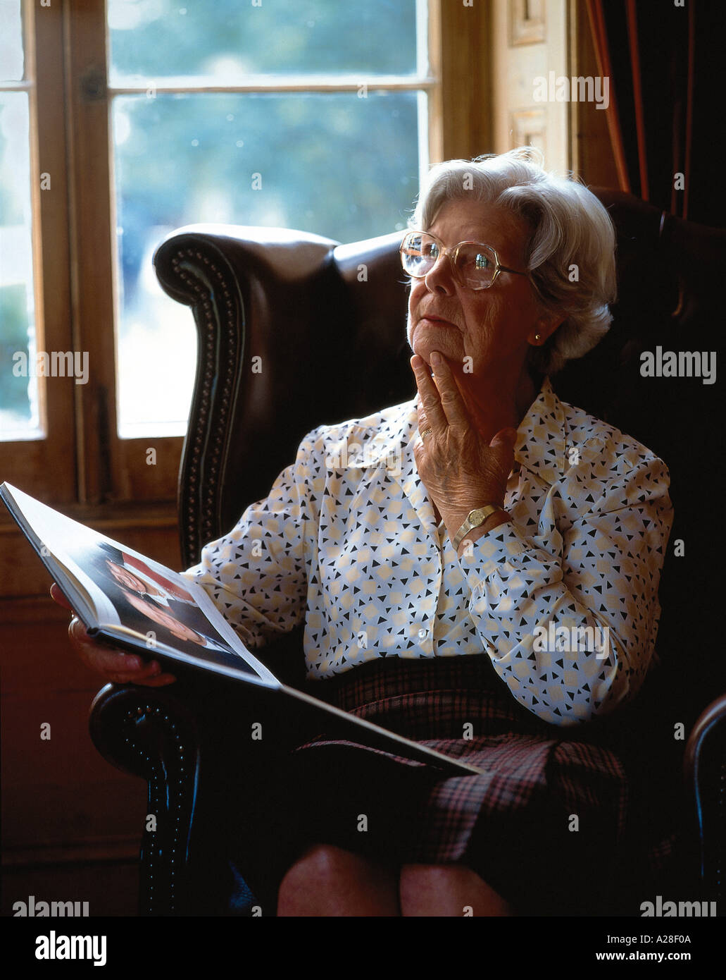Woman sitting alone chair hi-res stock photography and images - Alamy
