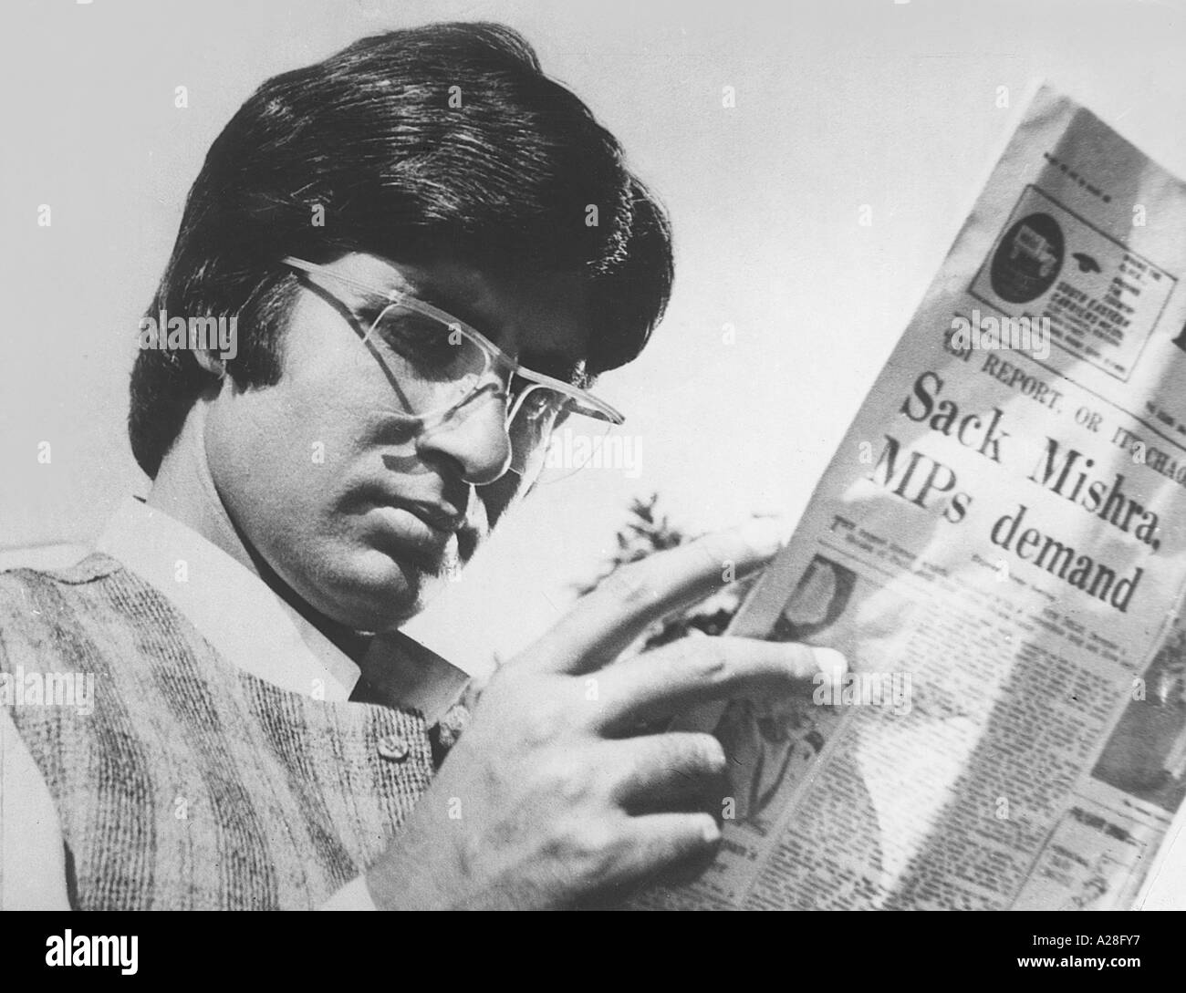 Indian Bollywood Film Star Actor Amitabh Bachchan reading news paper in Film Chupke Chupke Stock Photo