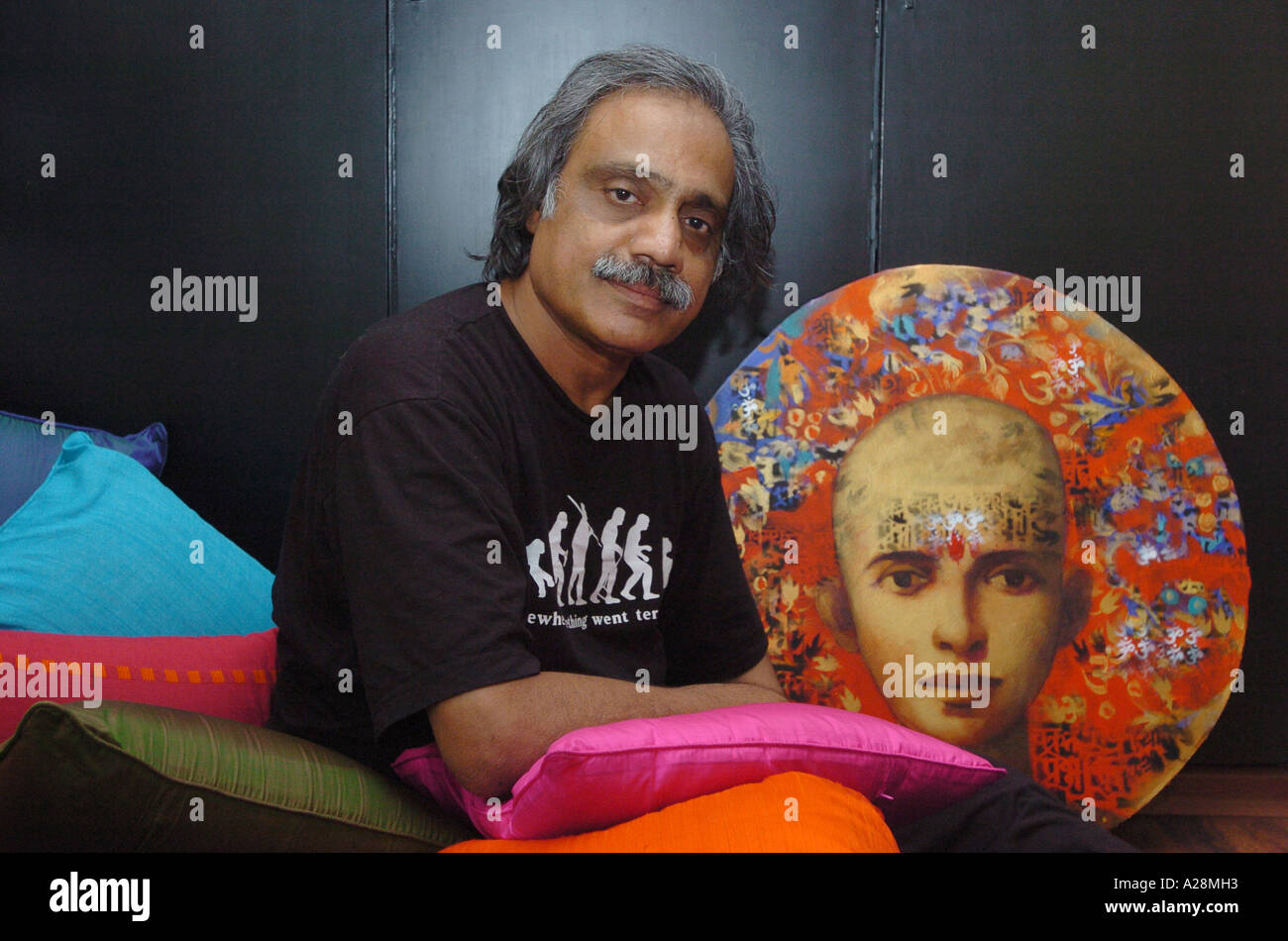 Subhash Awchat, Indian painter with one of his art works at his Bandra residence, Mumbai Maharashtra India Stock Photo