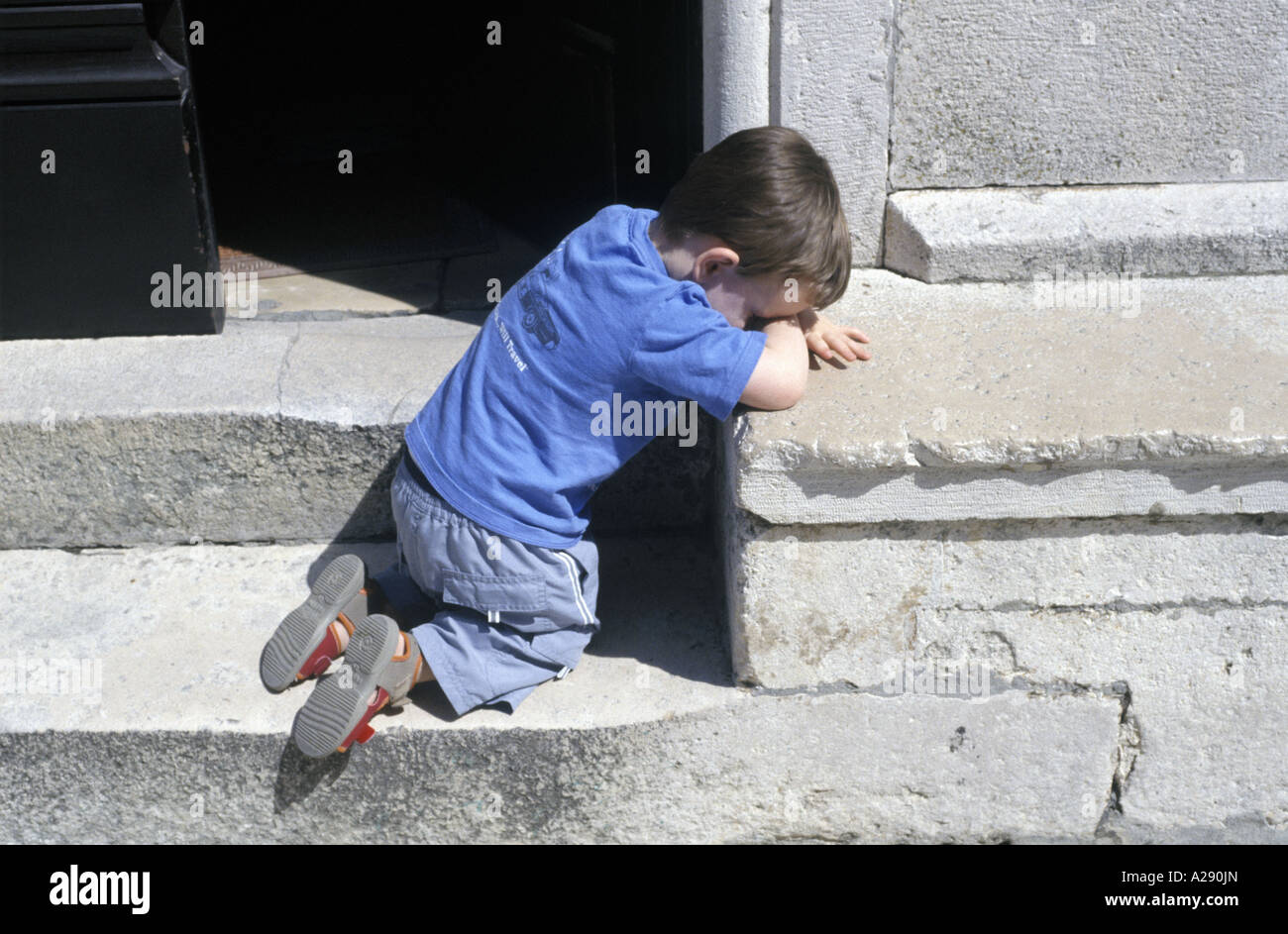 a young boy on a step Stock Photo