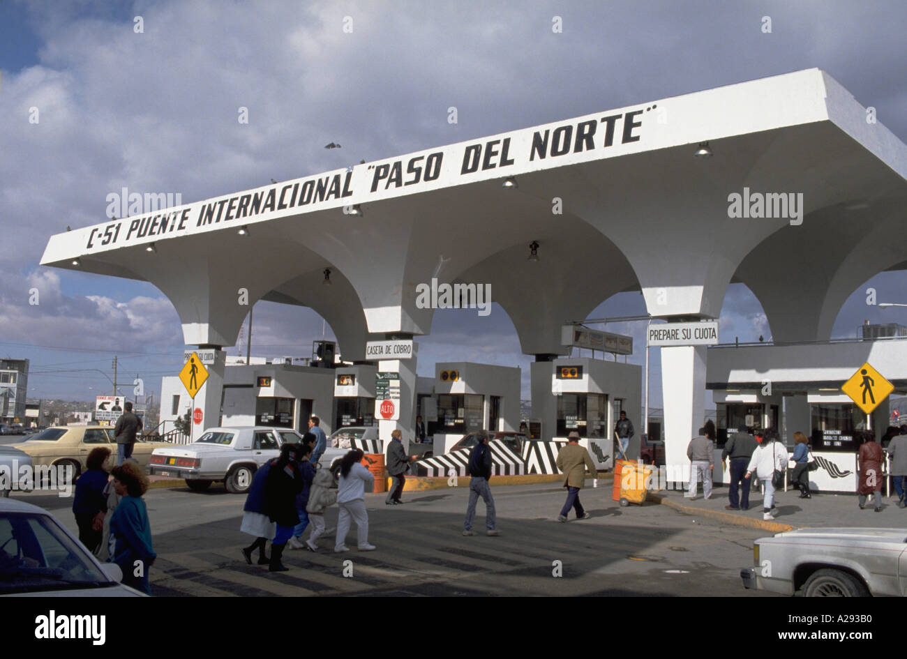 People and vehicles move toward the border and customs checkpoint on Avenida Juarez in Ciudad Juarez Mexico Stock Photo