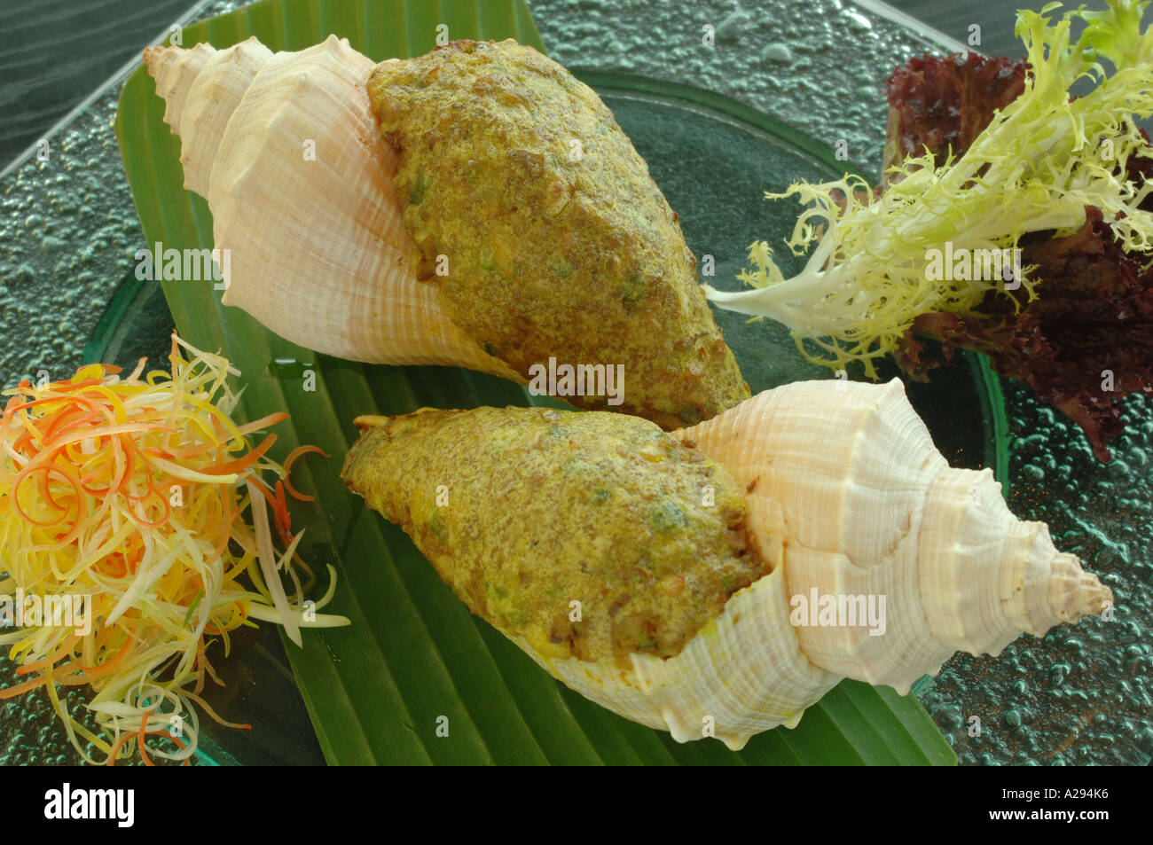 Baked stuffed conch with goose liver and fresh fungus Stock Photo