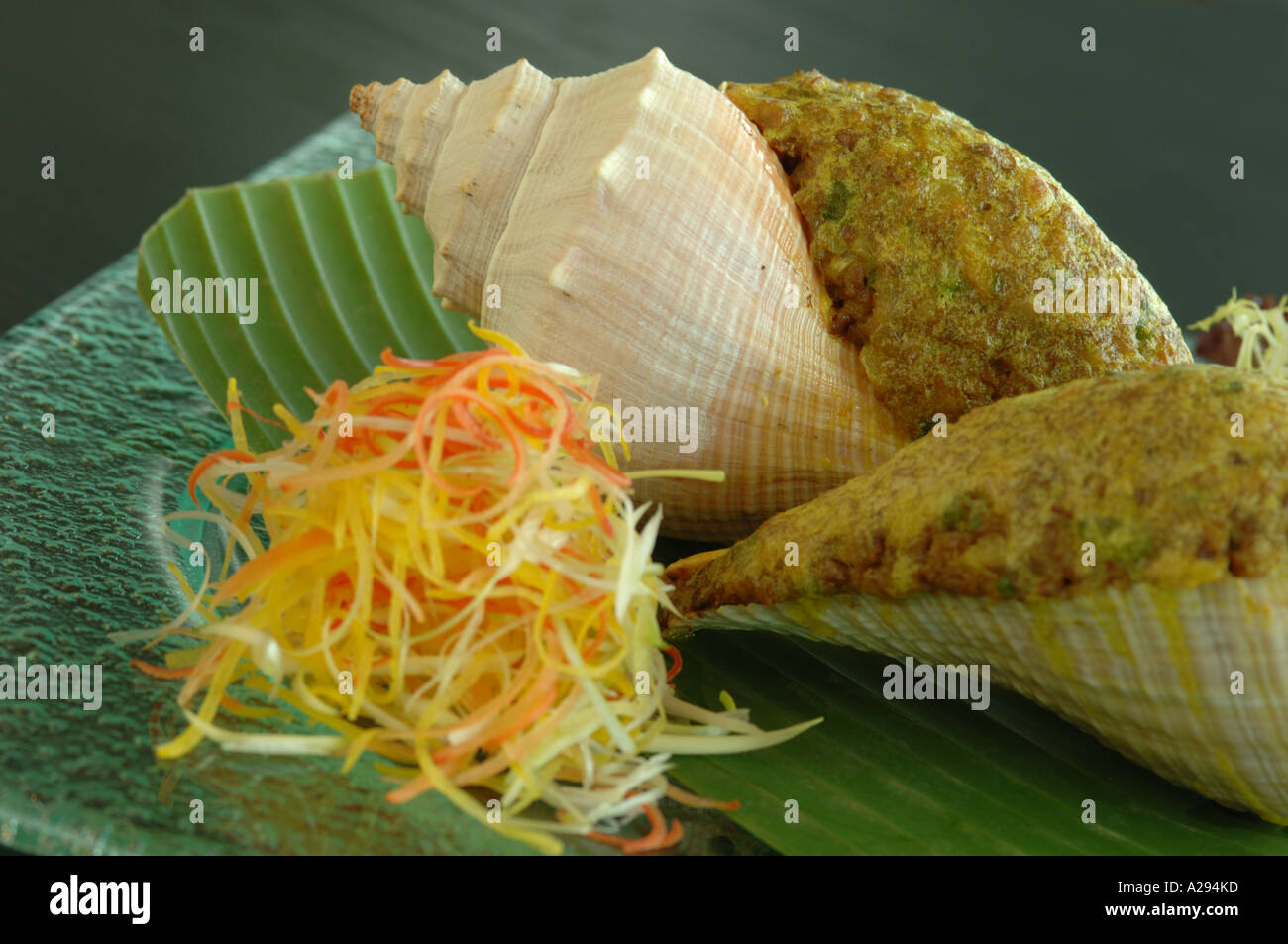 Baked stuffed conch with goose liver and fresh fungus Stock Photo - Alamy