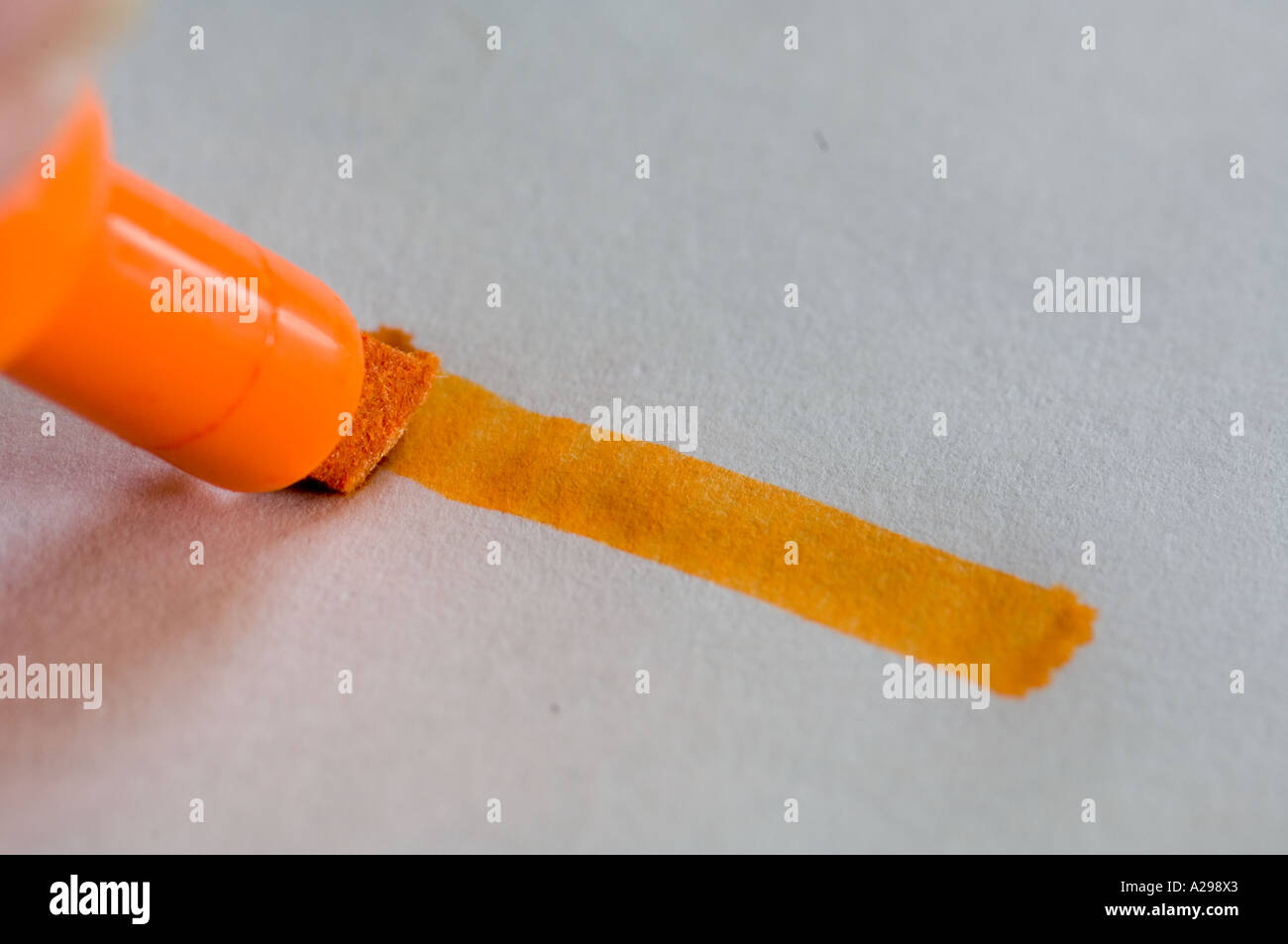 closeup of orange marking pen making streak Stock Photo
