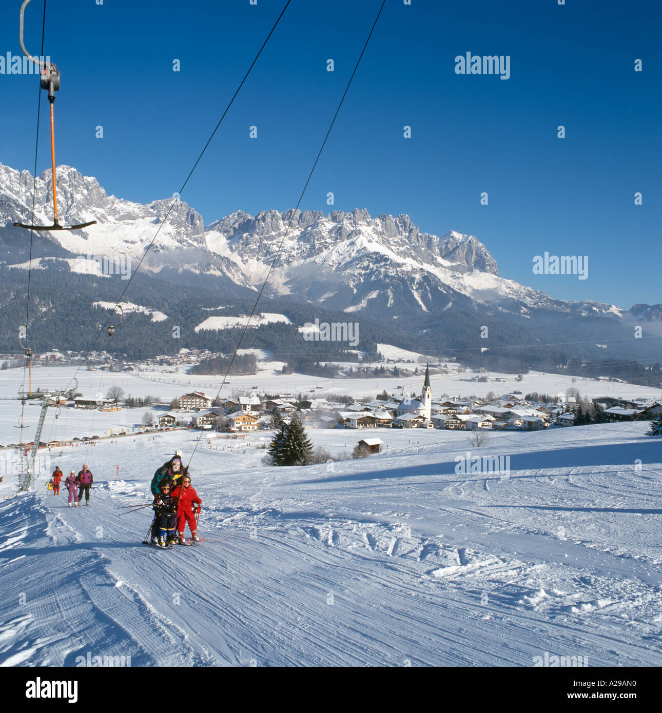 View from a drag lift on the lower slopes towards the town centre with Wilder Kaiser Mountains behind, Ellmau, Tyrol, Austria Stock Photo