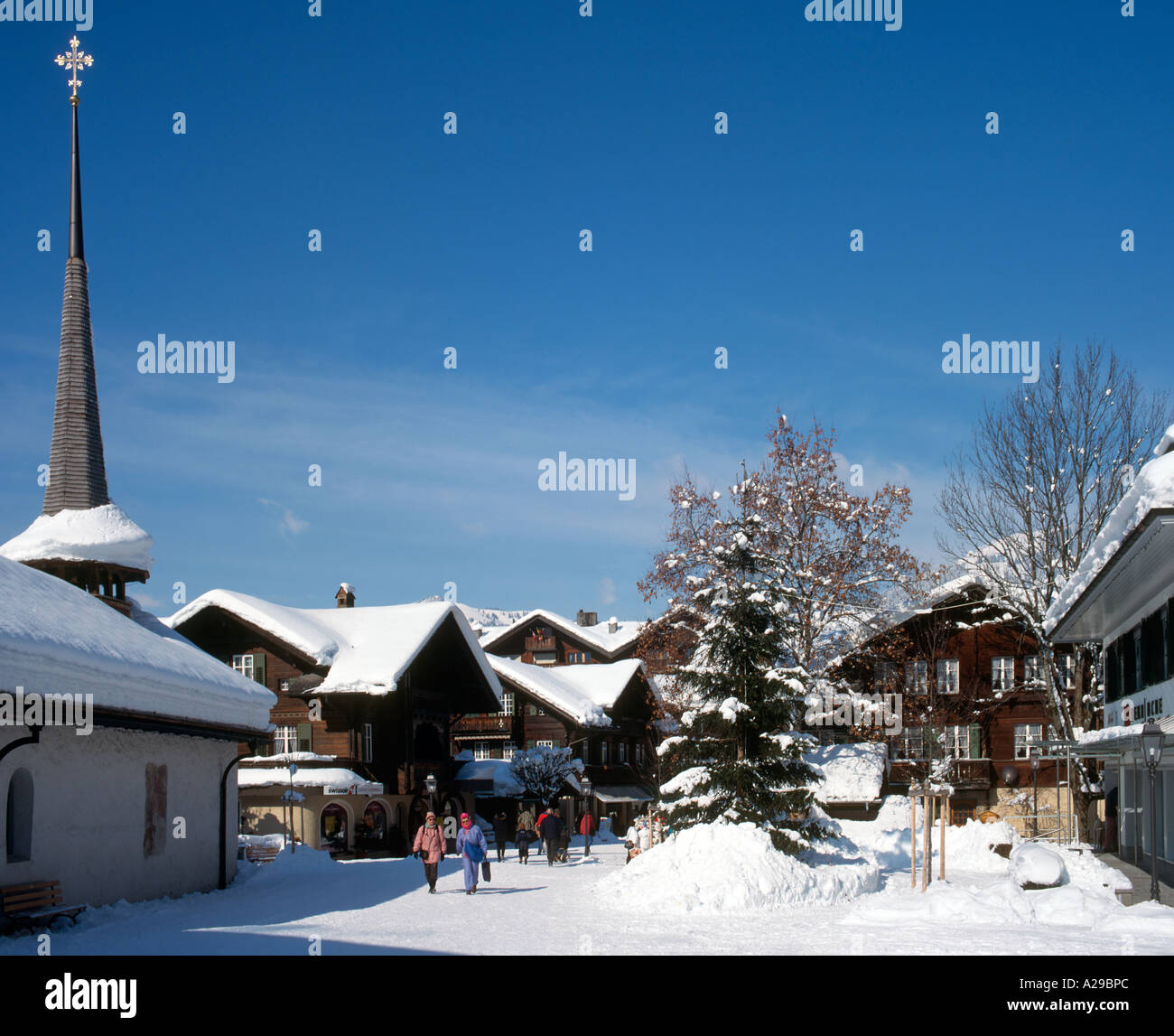 Shops and church in the resort centre of Gstaad, Swiss Alps, Switzerland Stock Photo