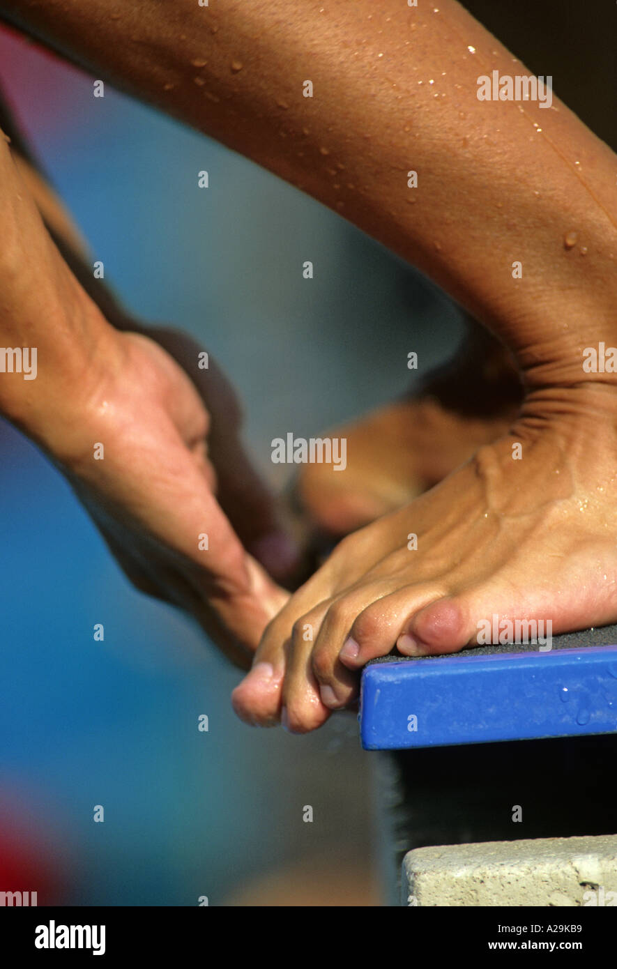 Close up of the toes and foot of a swimmer on the starting blocks Stock Photo