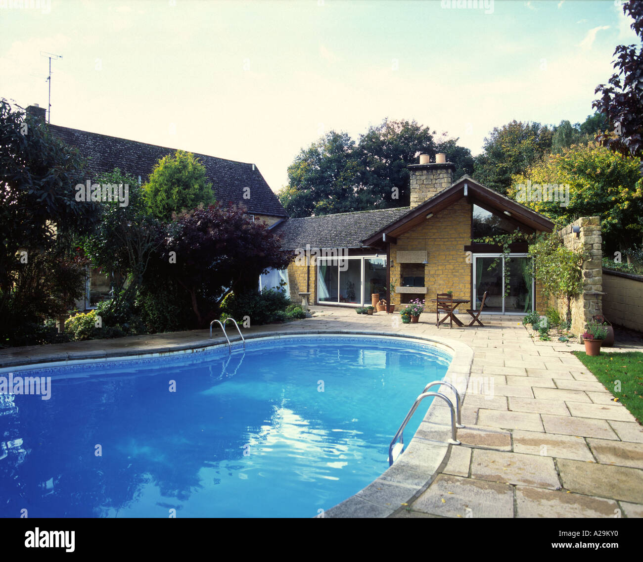 Outdoor swimming pool in grounds of house Stock Photo