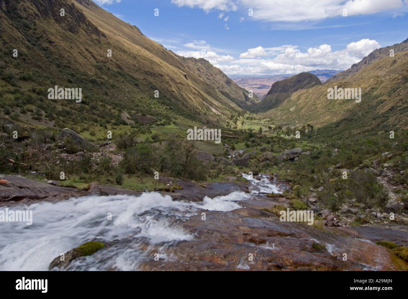 A waterfall and rugged mountain scenery while on the 'community' Inca trail with a slow shutter speed to blur the motion. Stock Photo