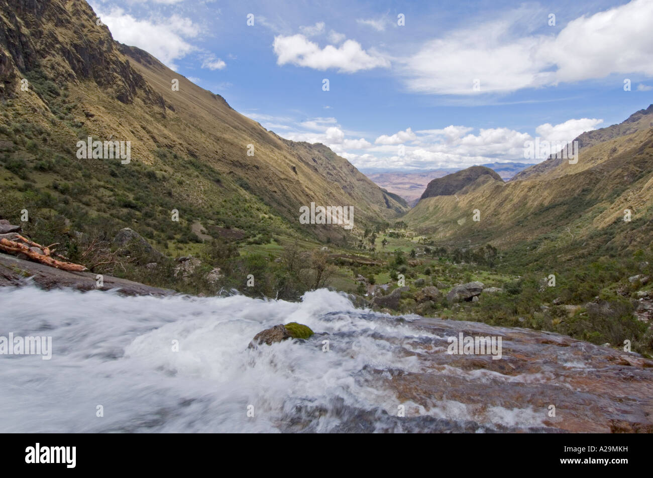 A waterfall and rugged mountain scenery while on the 'community' Inca trail with a slow shutter speed to blur the motion. Stock Photo