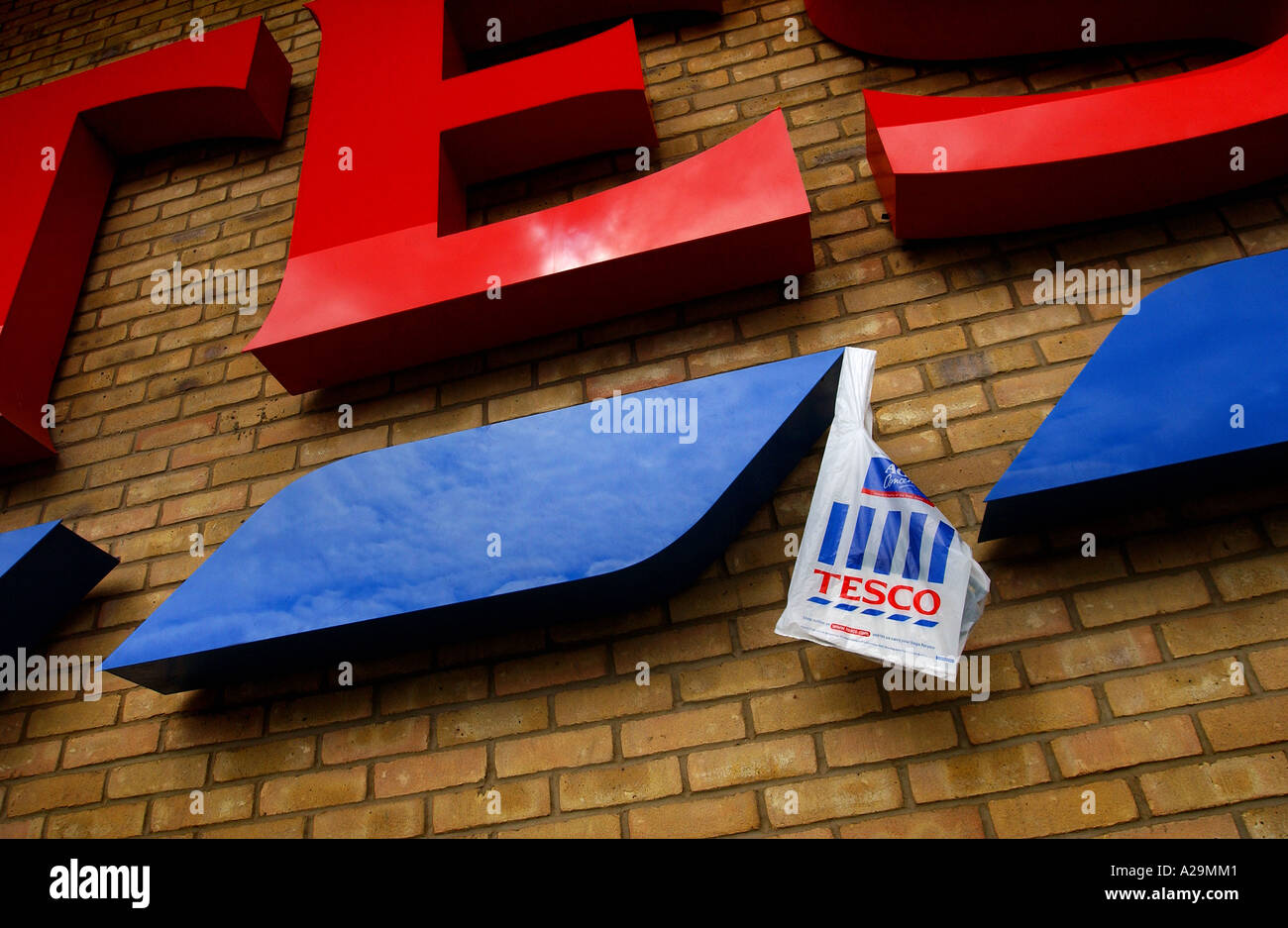 A plastic shopping bag hanging from a tesco super market sign in Taunton, Somerset, UK. Stock Photo