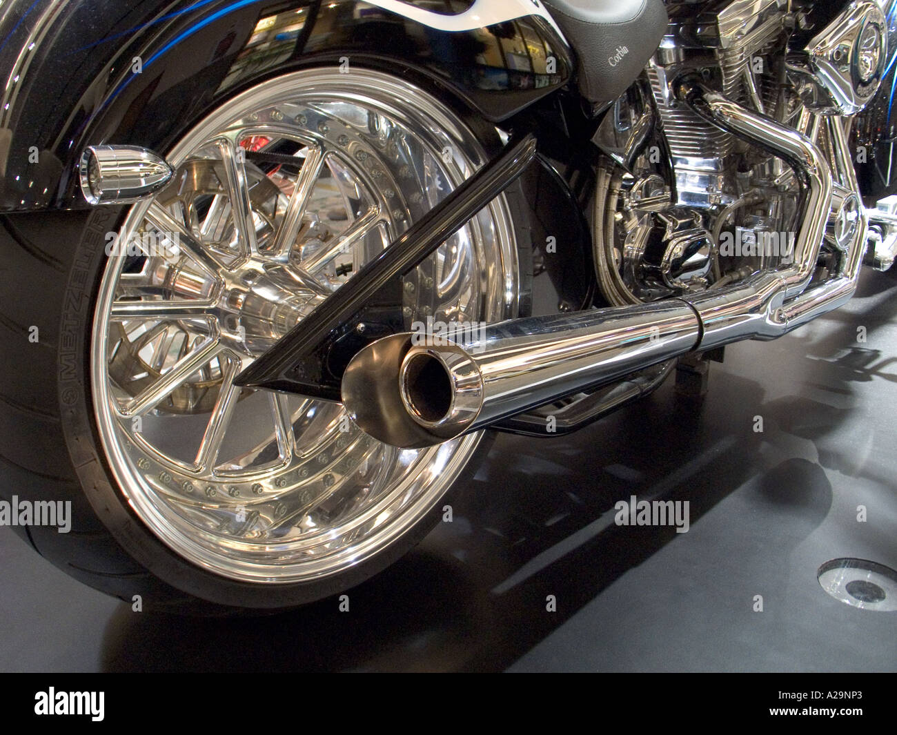 Rear chrome wheel and pipes of a custom chopper motercyle Stock Photo ...