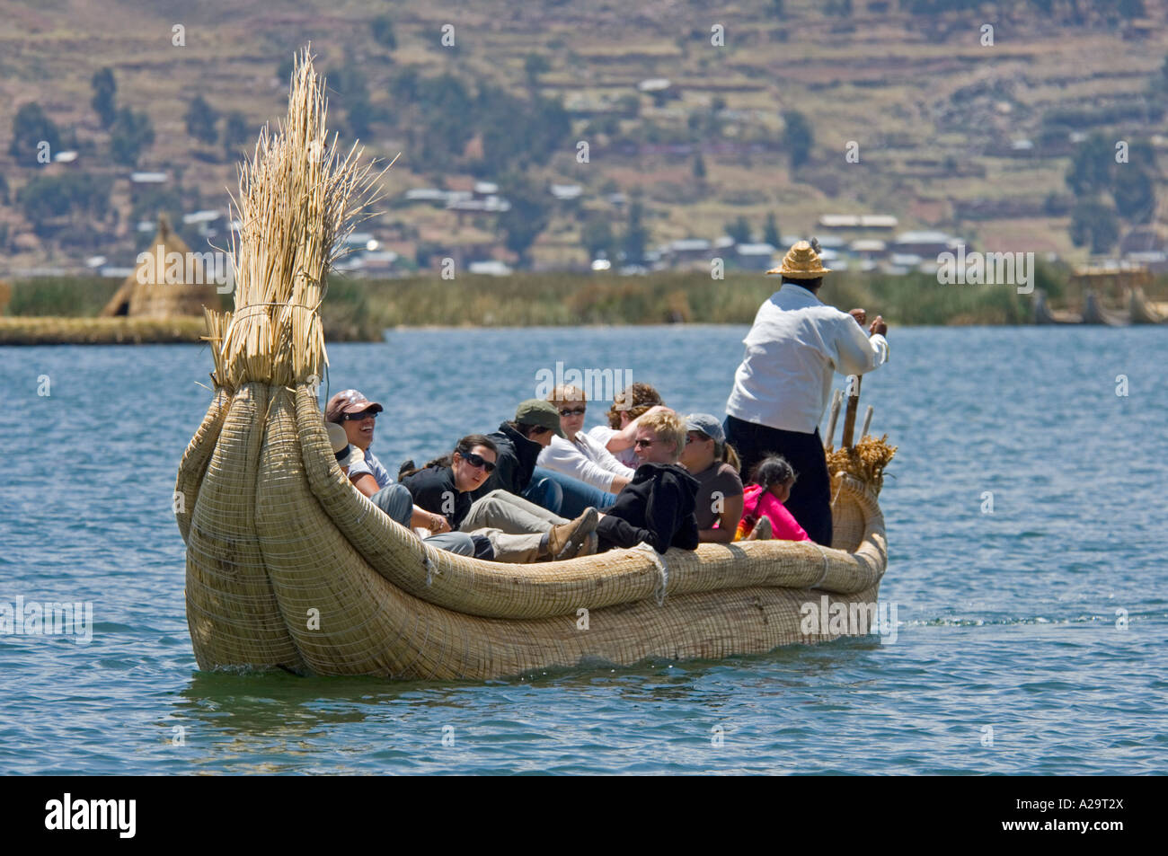 Titicaca Reed Raft A group of tourists take a trip on a traditional reed boat on Lake ...