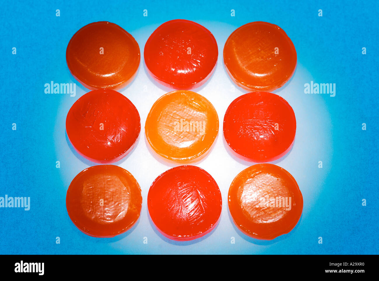 Orange lozenges on blue background Stock Photo