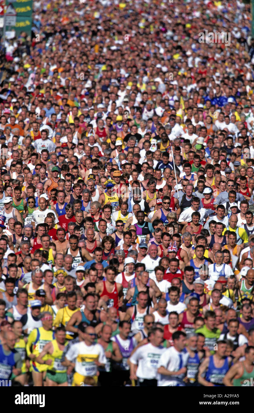 A crowd of hundreds of runners at the start of the London Marathon ...