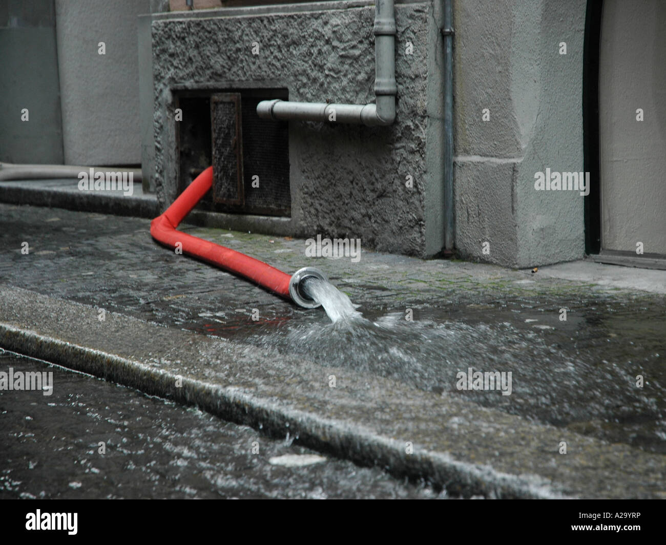 pumping water out of a building after a flooding Stock Photo