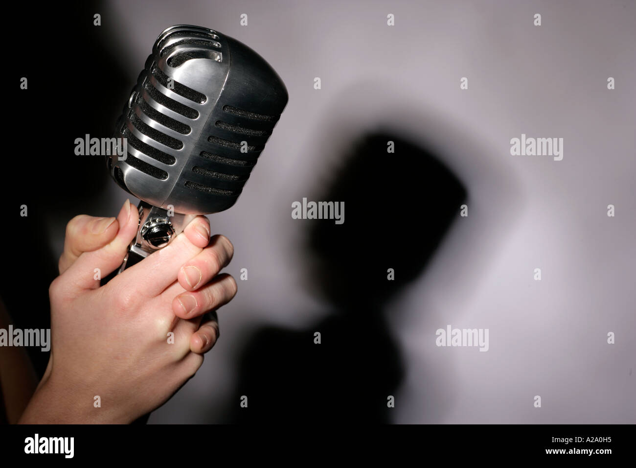 a fifties or sixties style microphone recording singing night nightime nightclub club bar Stock Photo