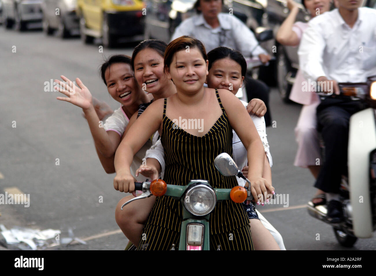 Four vietnamese girls on one motorbike Stock Photo - Alamy