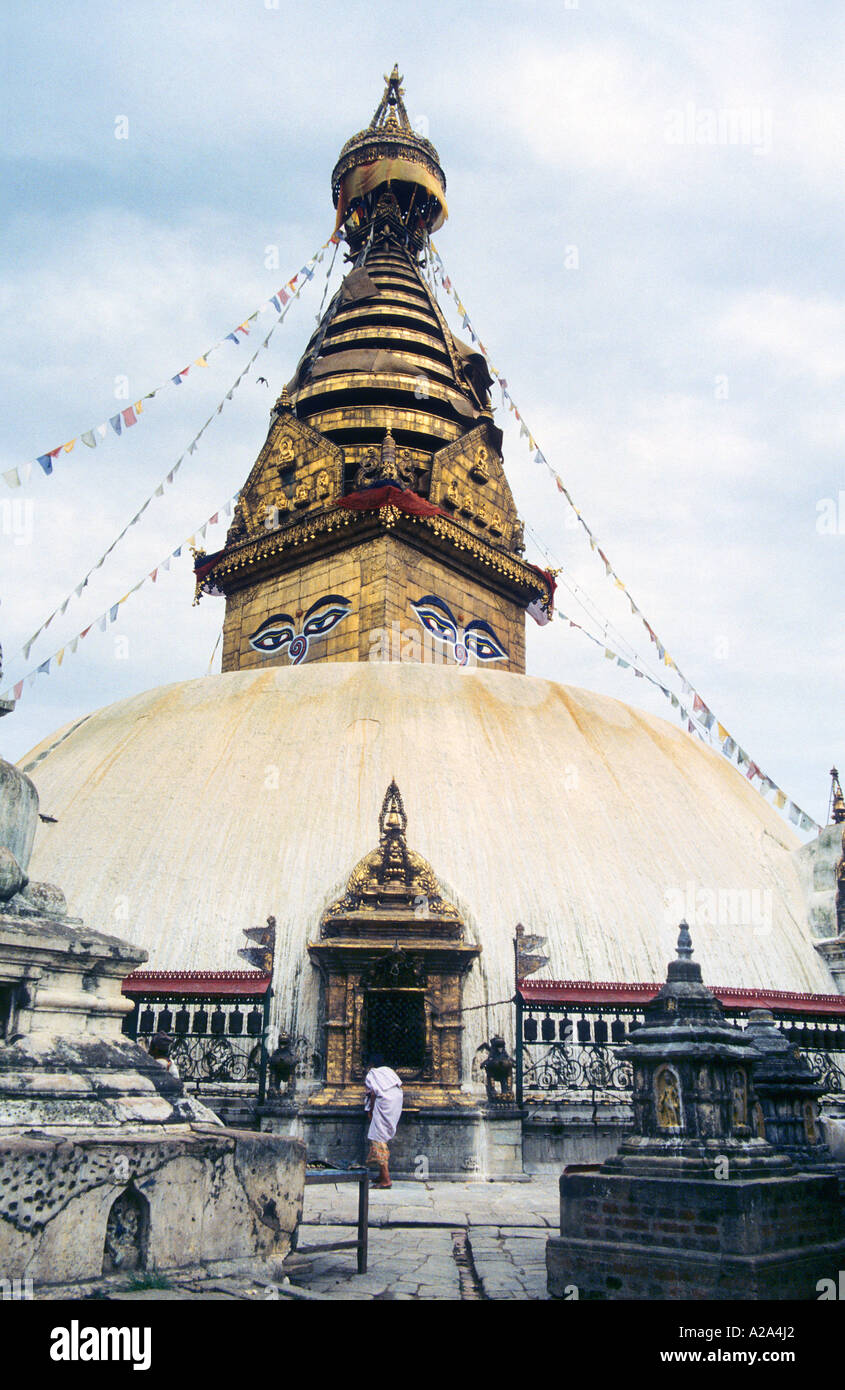 Prayer Buddha Buddhist temple stupa in Kathmandu Nepal stone carving monument rice offering square Swayambhunath Stock Photo