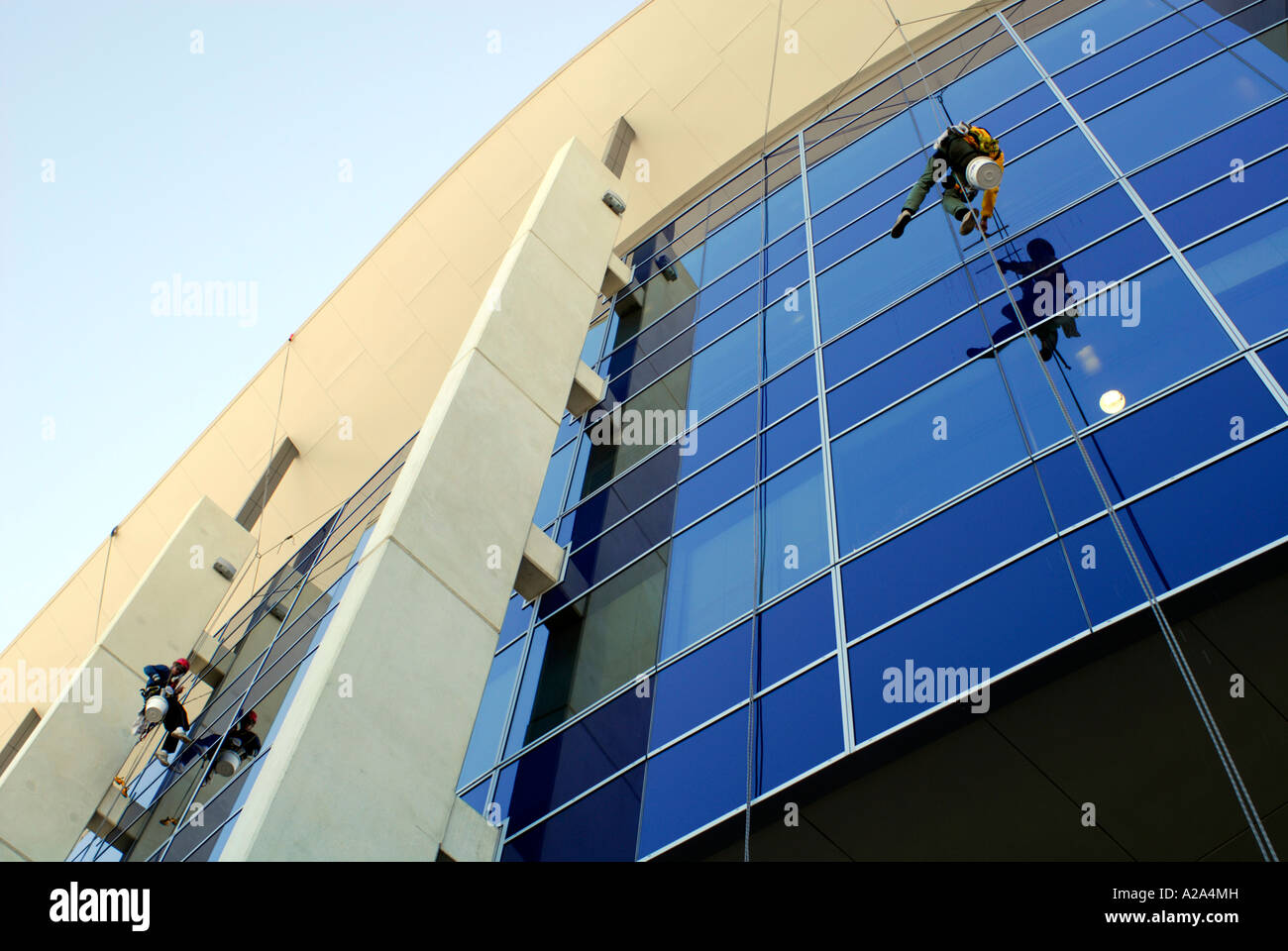 window cleaners on side of multi story building Stock Photo Alamy