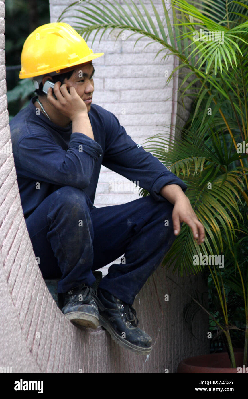 Construction worker talking on his mobile phone, Hong Kong SAR Stock Photo