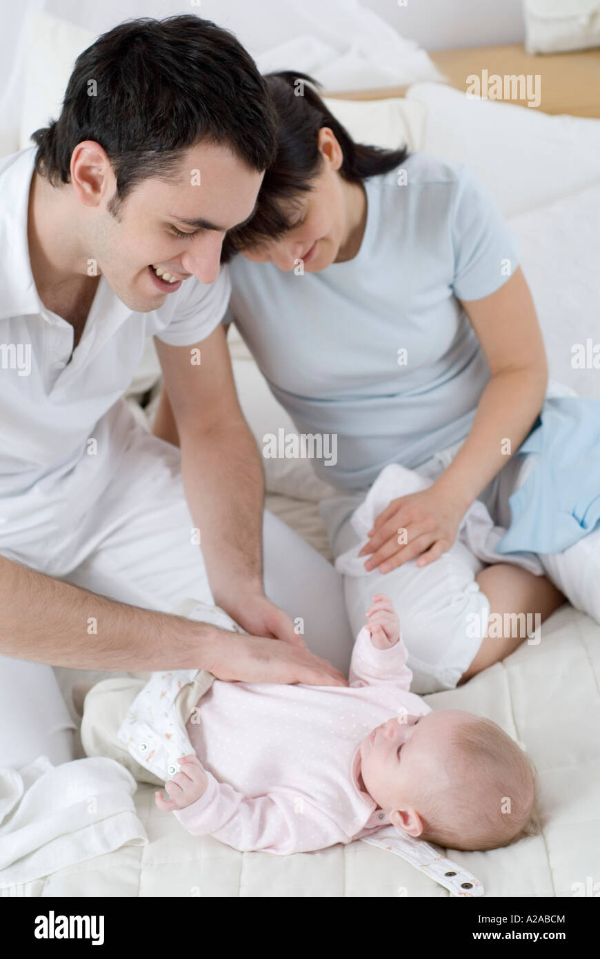 parents changing their baby's diaper Stock Photo Alamy
