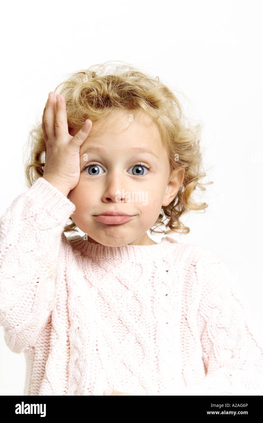 Funny face young girl 3 4 5 years slapping head Stock Photo