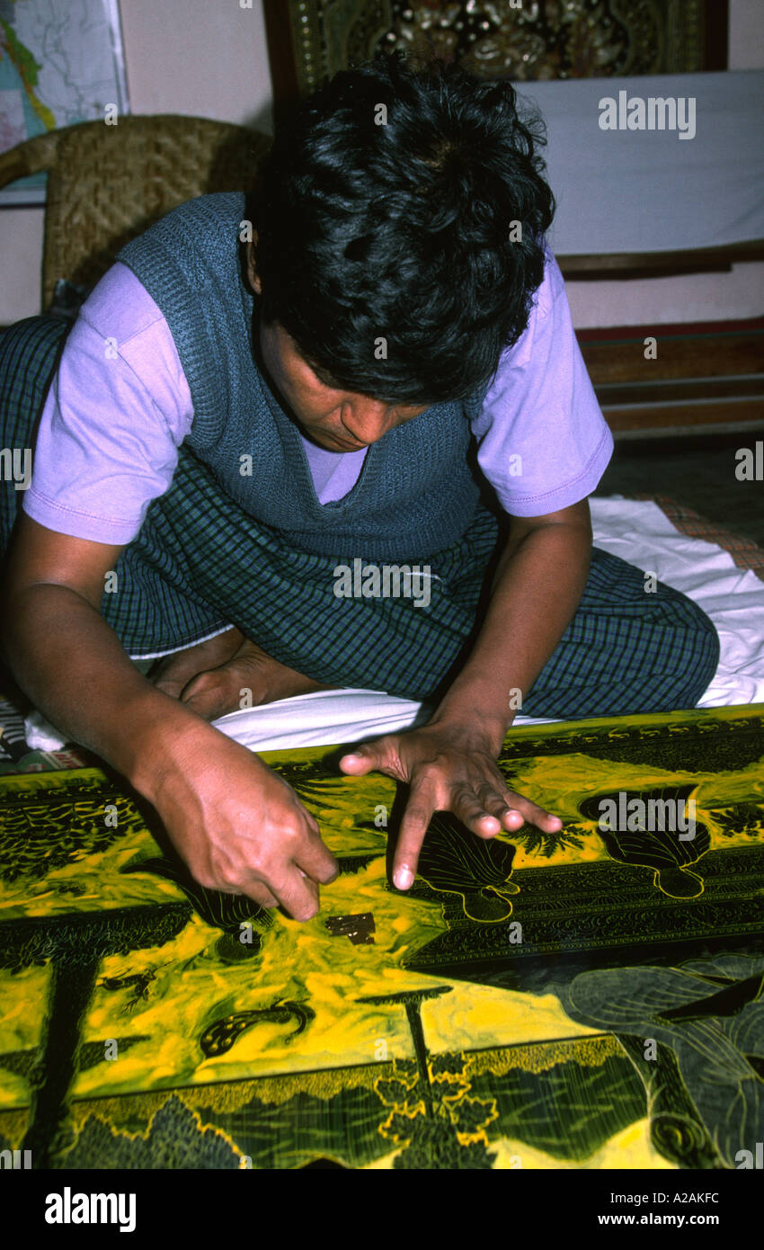 Myanmar Burma Pagan crafts man applying gold leaf to lacquer panel Stock Photo