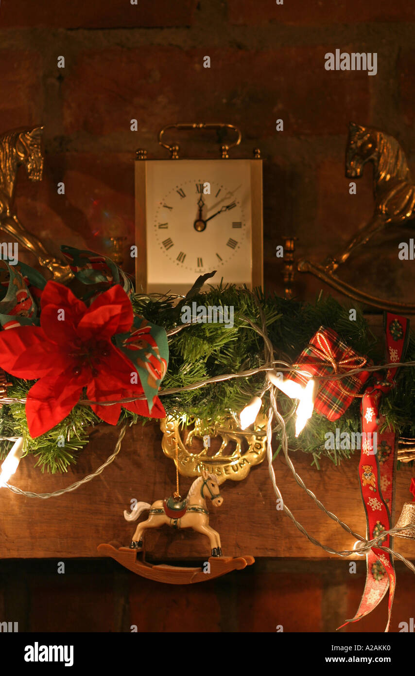 Christmas lights and decorated swag over an open fire place Stock Photo