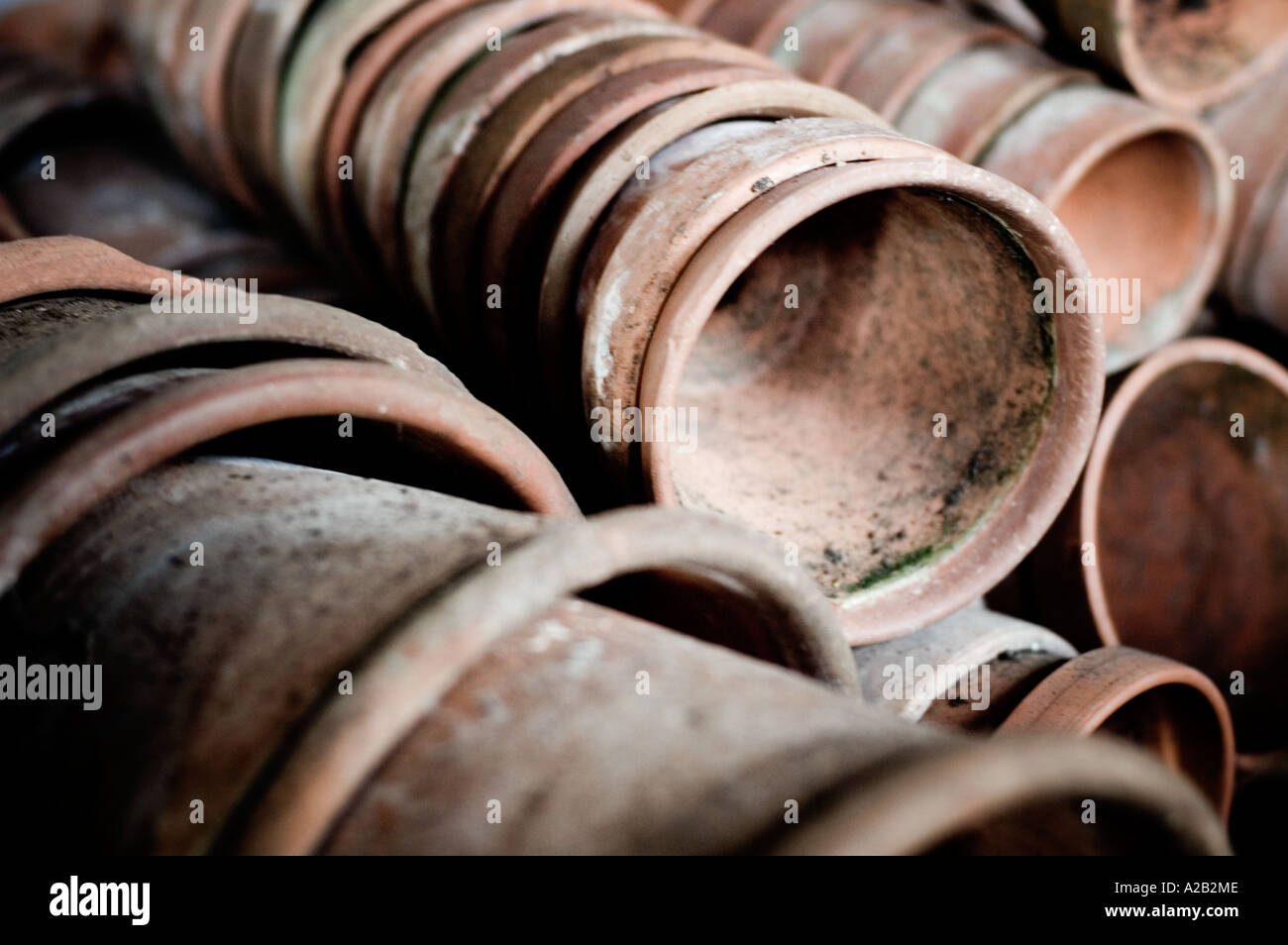 A stack of old terracotta pots in a garden shed Stock Photo - Alamy