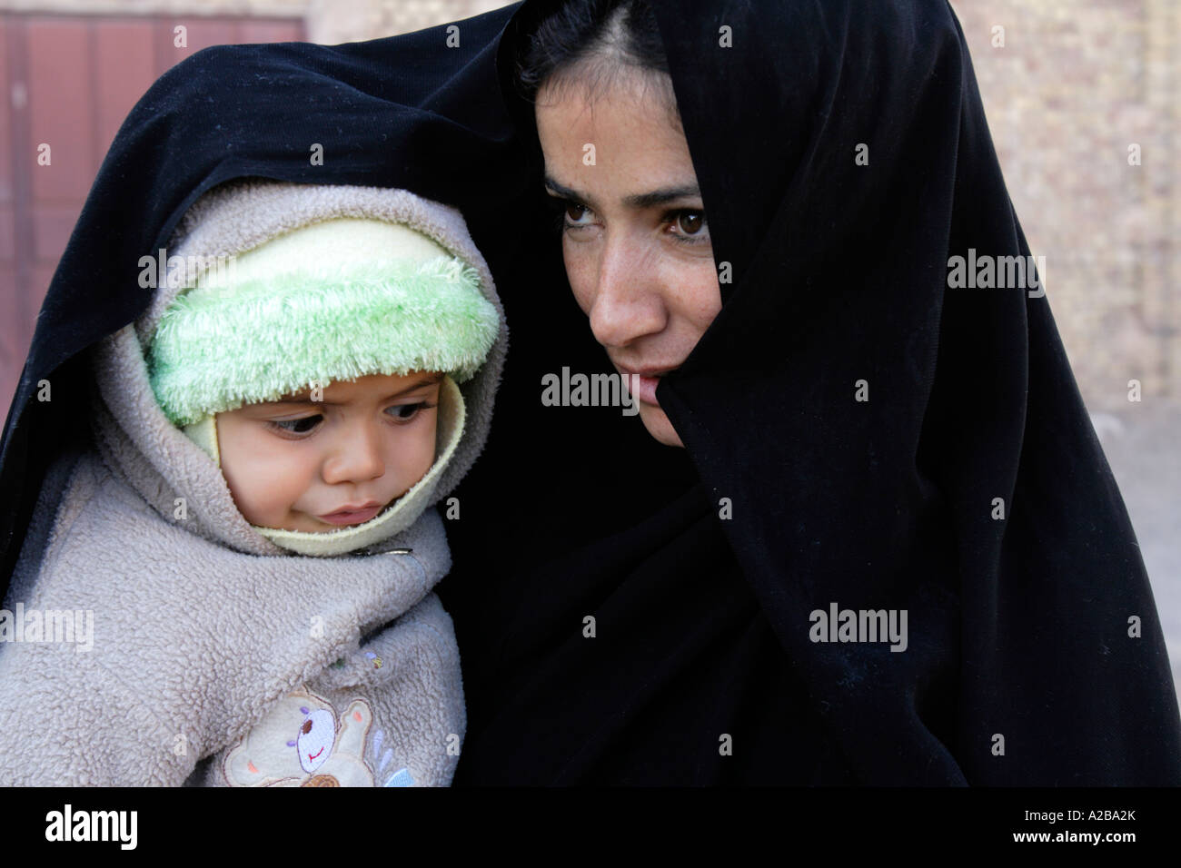 Iranian woman, dressing the traditional chador, with her son, Iran ...