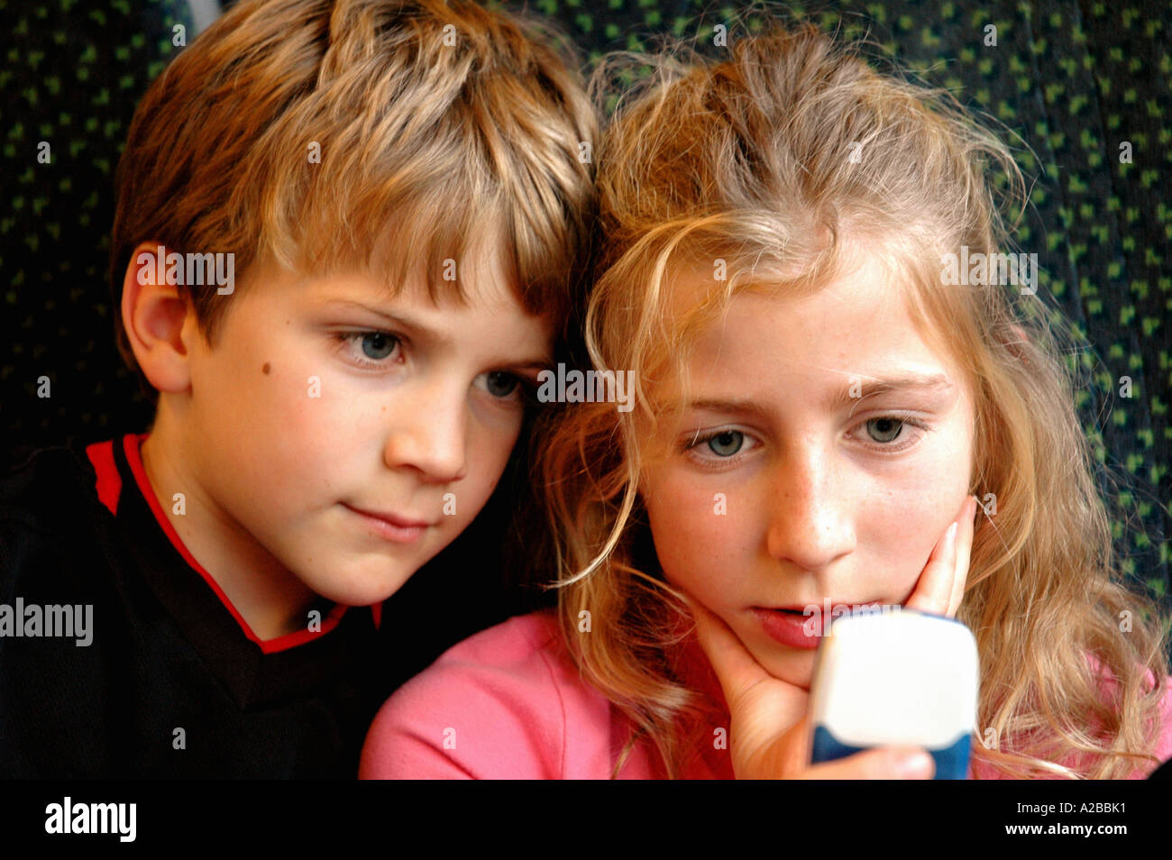 children playing games on a mobile phone Stock Photo