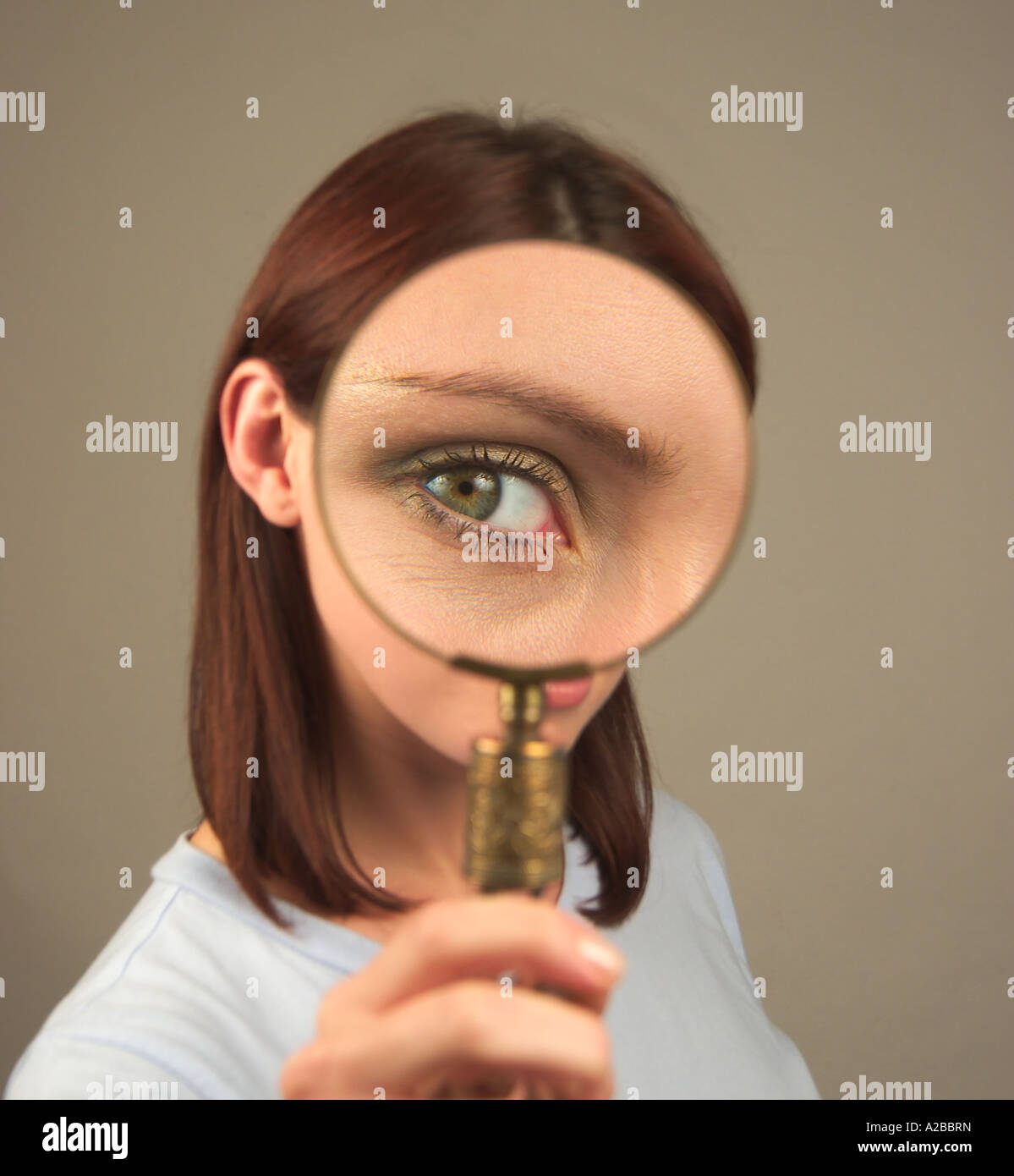 woman looking through a magnifying glass Stock Photo - Alamy