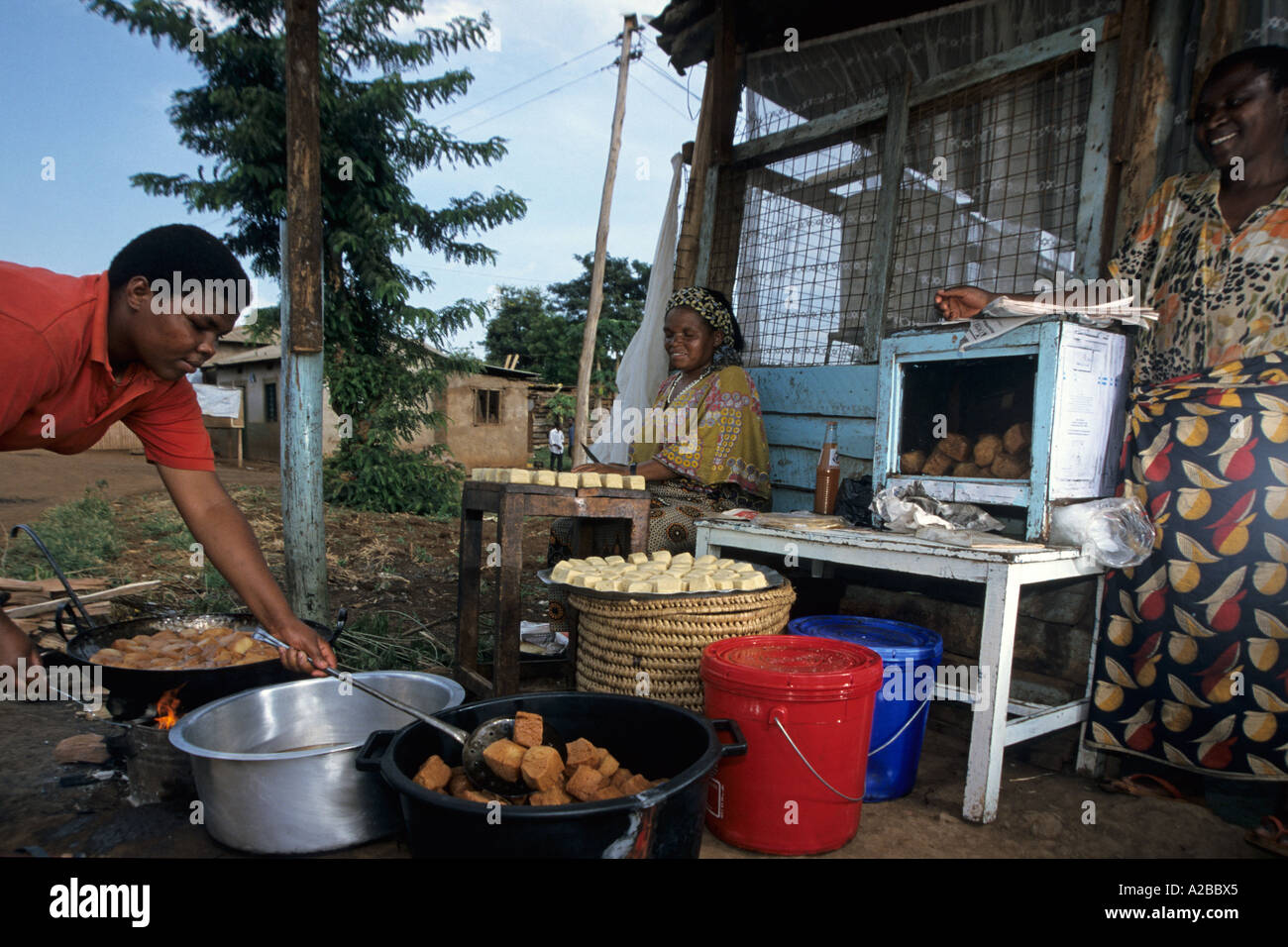 Women cooking in makeshift restaurant; Moshi; Tanzania Stock Photo