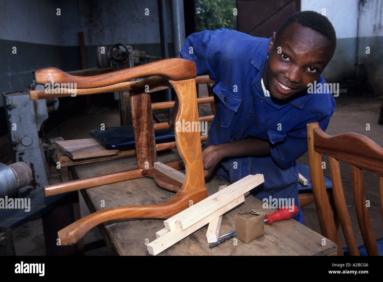 Carpenter trainee working on a chair, Moshi, Tanzania Stock Photo