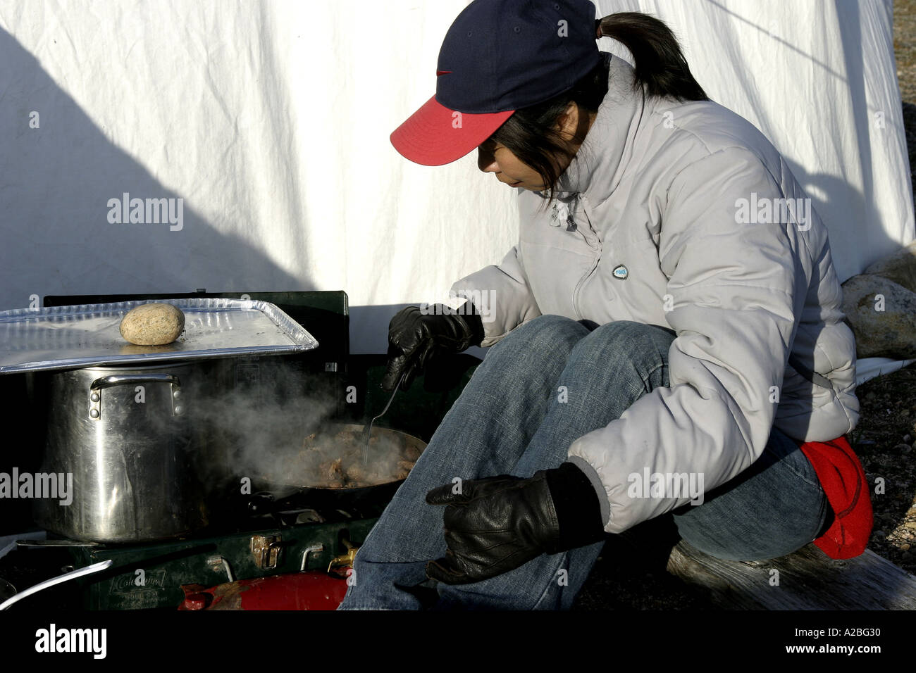 Chinese woman cooking at camp York Sound Baffin Island Nunavut Stock