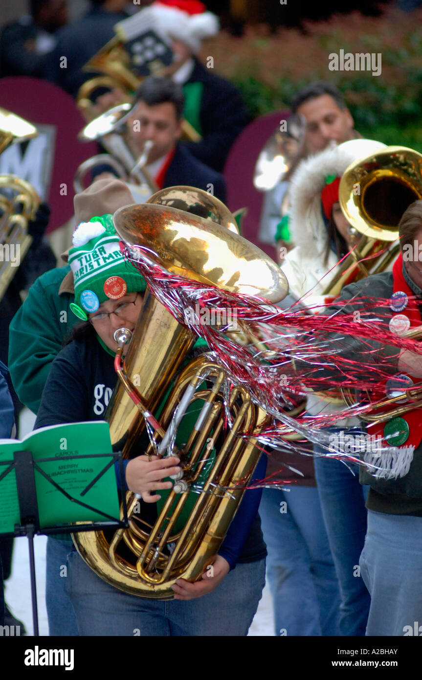 Bass and tenor tuba players gather on the The Rink at Rockefeller