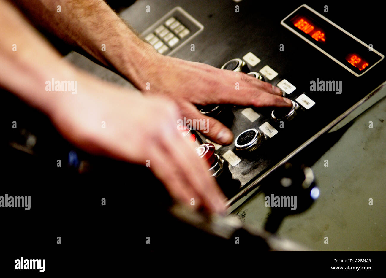 Man in factory using control panel Stock Photo - Alamy