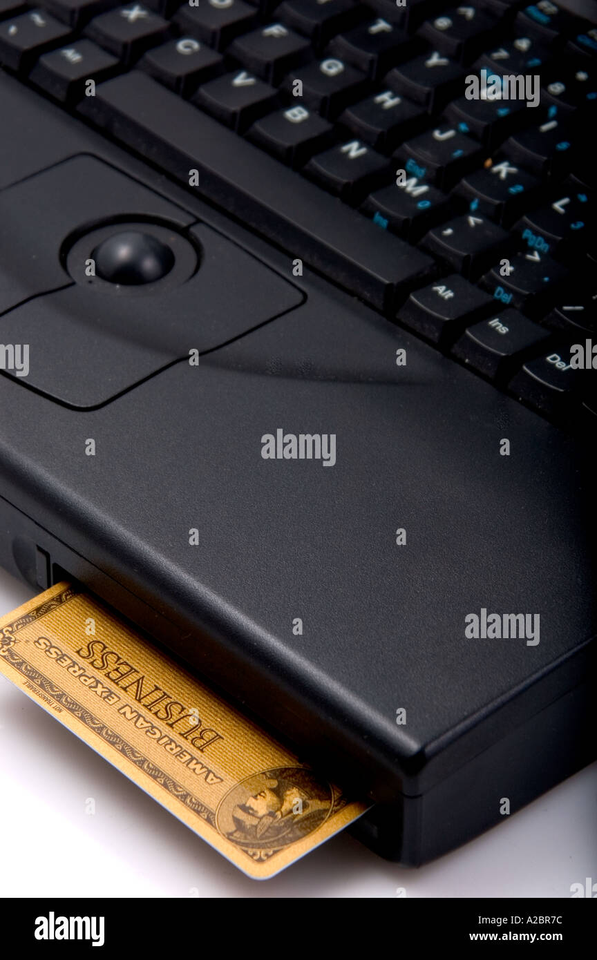 Laptop computer with American Express card in drive slot Stock Photo