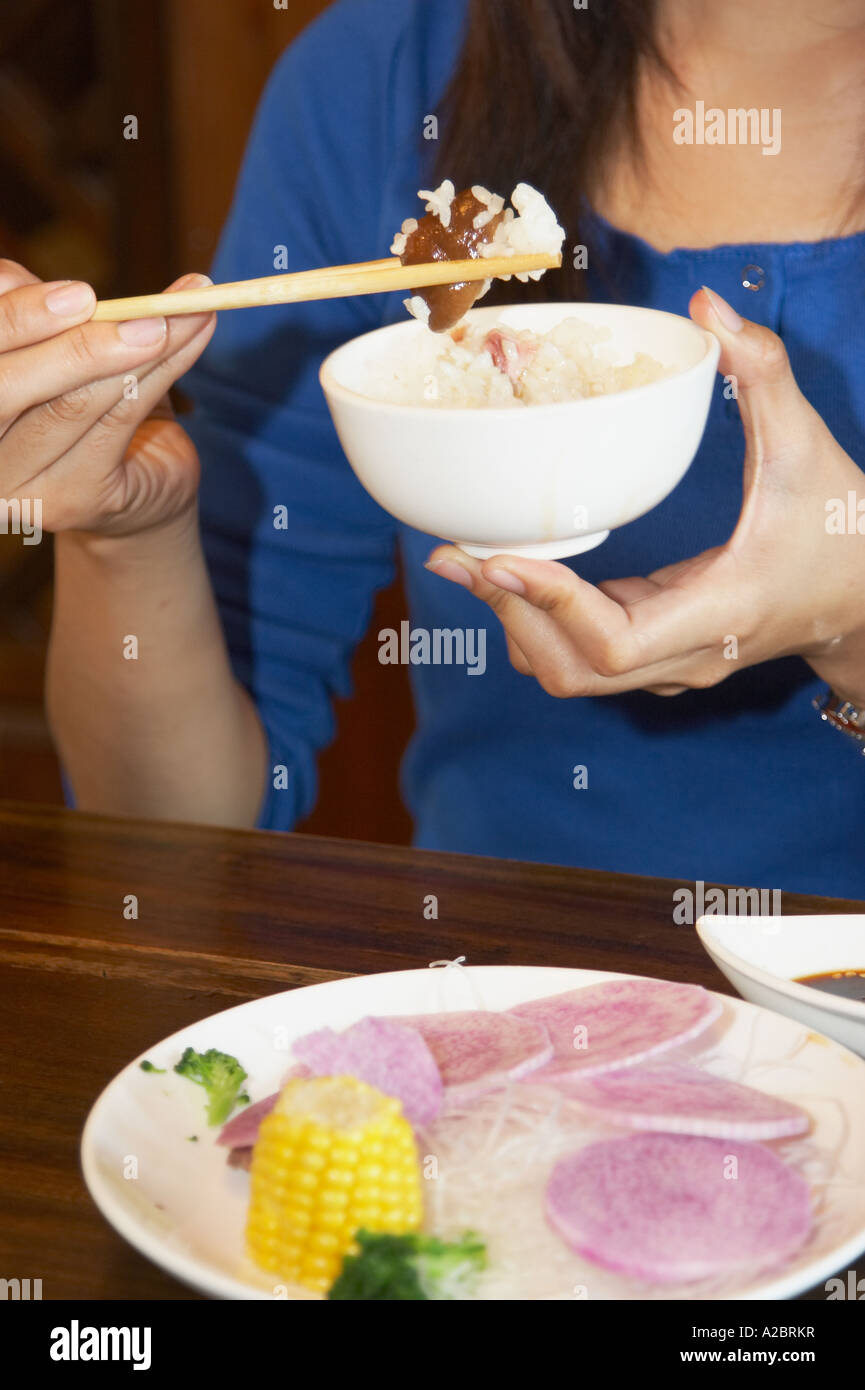 Chinese Woman Using Chopsticks To Eat Stock Photo Alamy