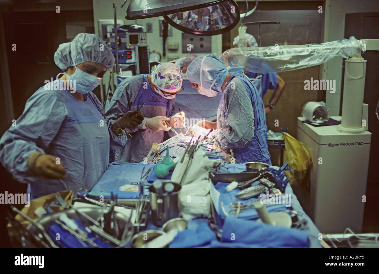 doctors and nurses performing surgery in hospital operating room Stock Photo