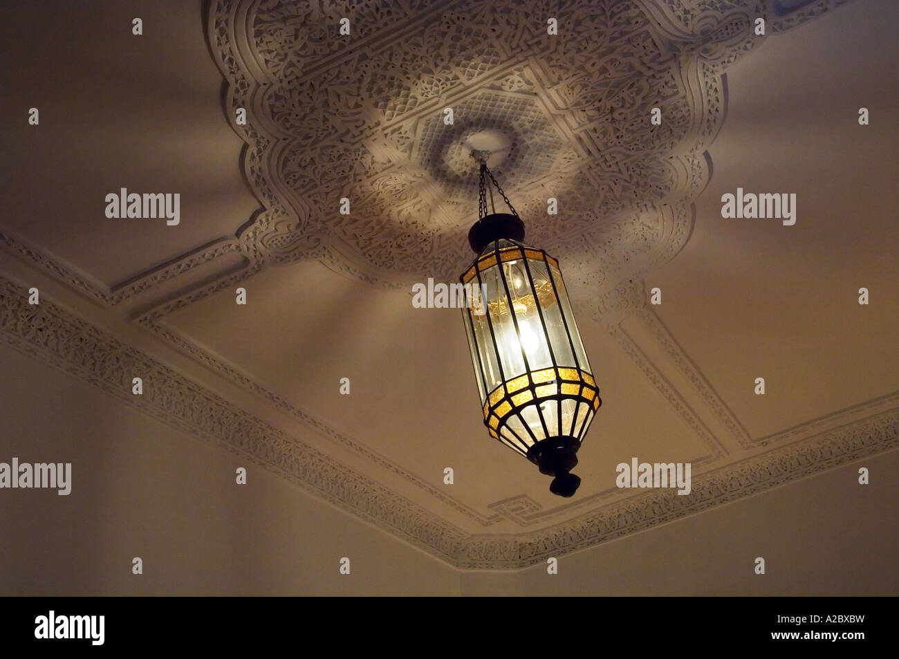 Ceiling detail and hanging lamp at Terrasse des Oliviers traditional restored guesthouse Marrakech Morocco Stock Photo