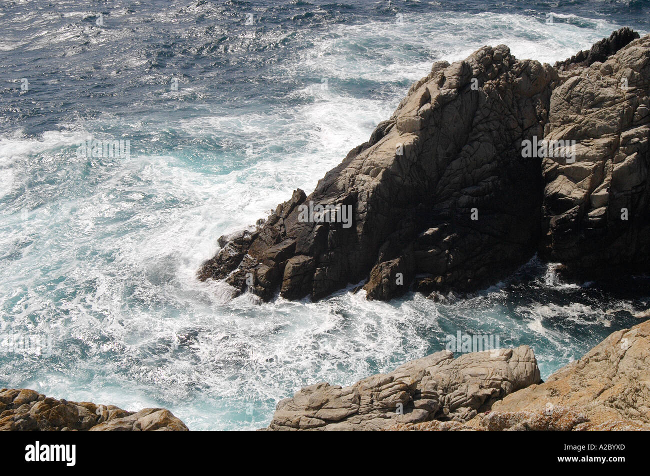 Wave Passing Between Two Rocks Waves splashing between rocks Stock Photo - Alamy