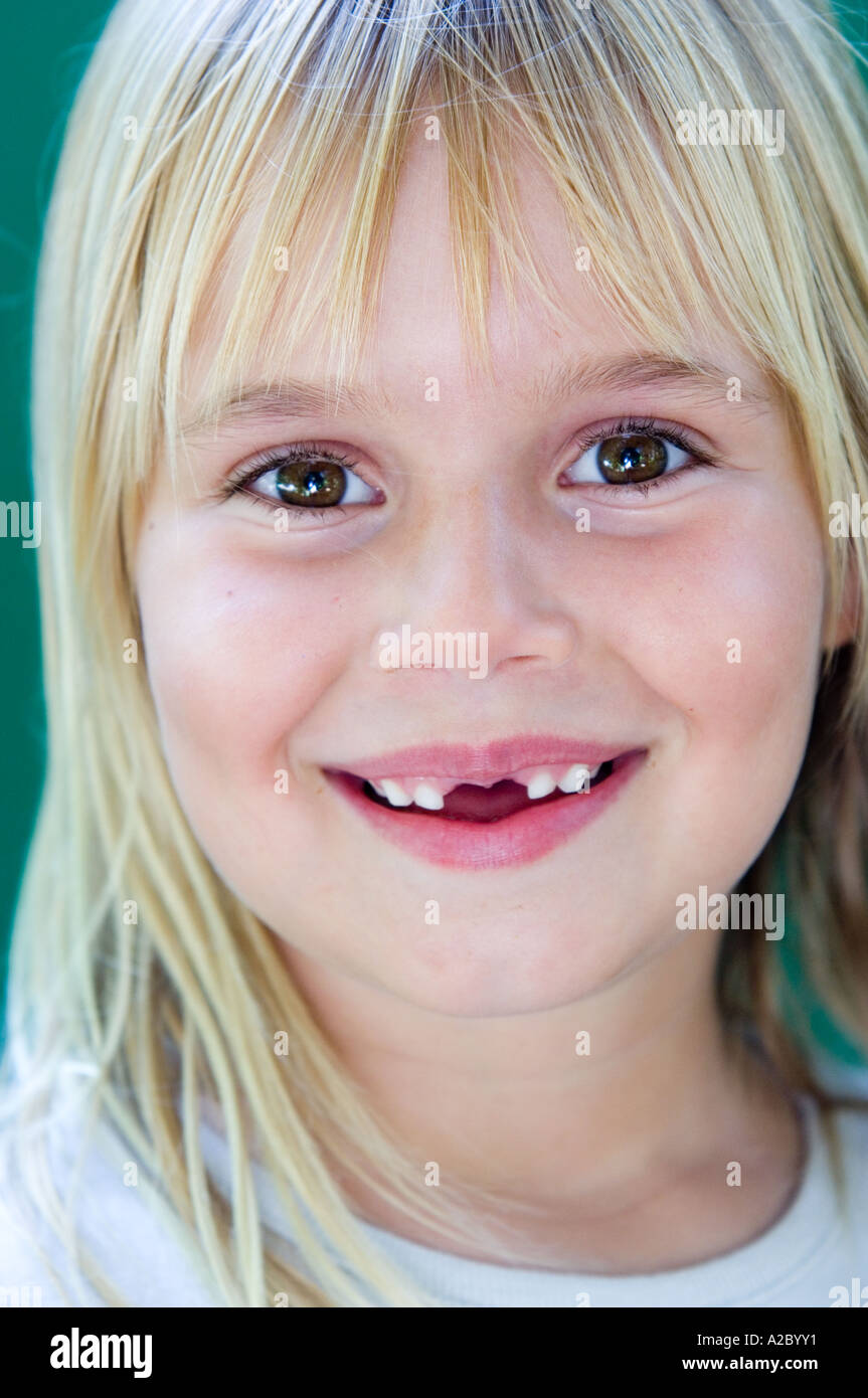 A young blond girl smiles into the camera Stock Photo - Alamy